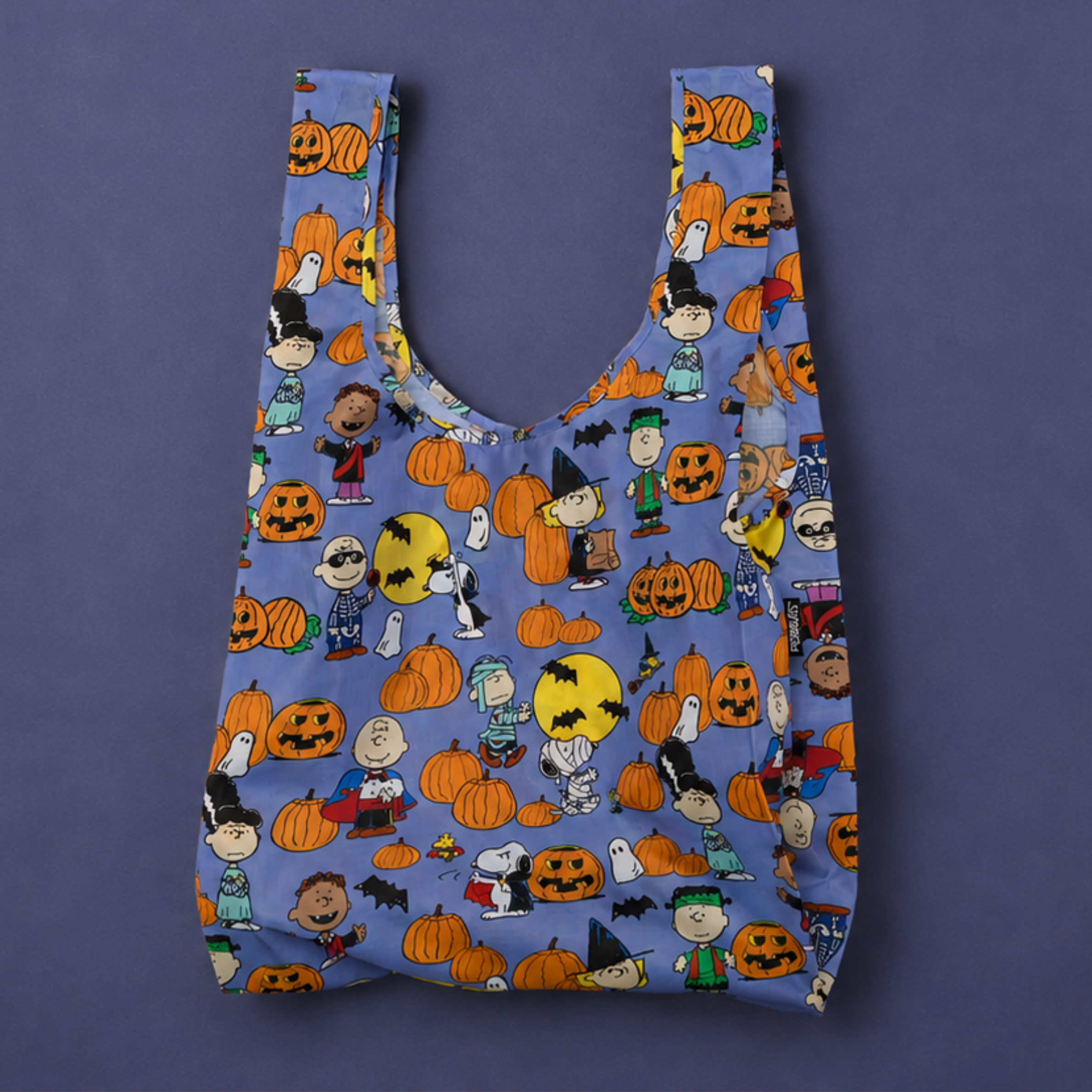 a Peanuts themed purple Baggu standard nylon tote bag.