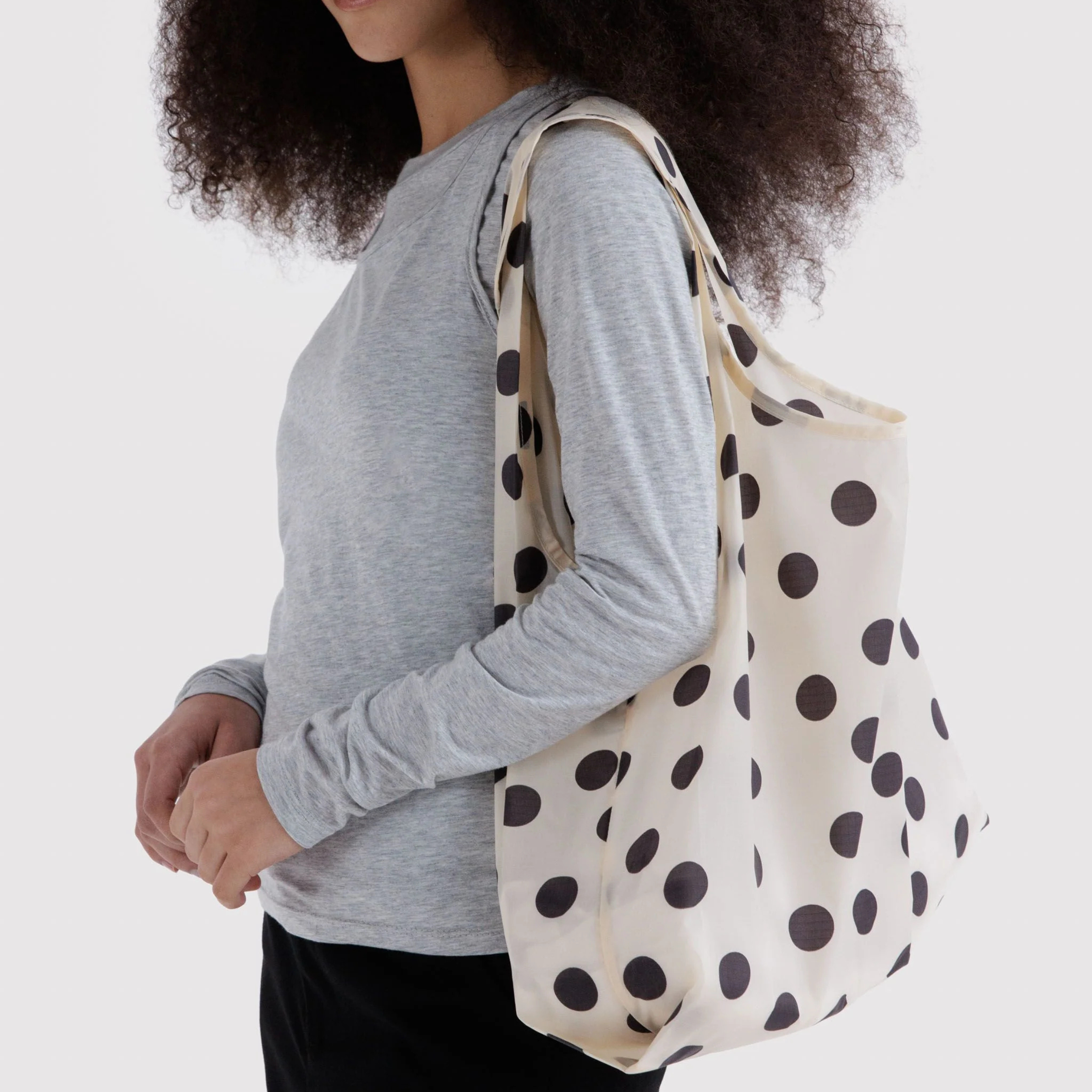 A cream and black polka dot nylon tote.
