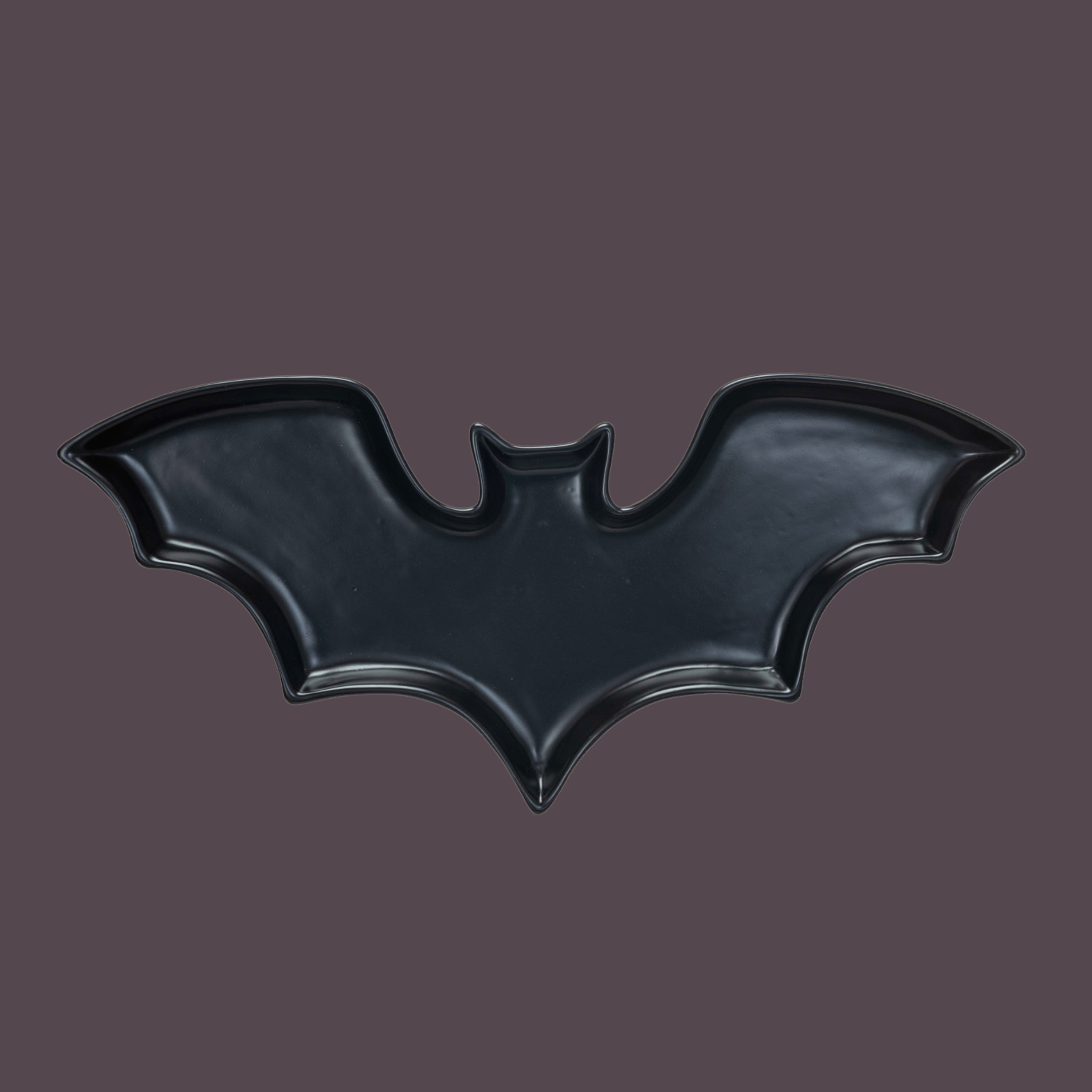 a black bat shaped dish