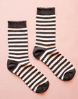 A pair of black and cream striped crew socks. 