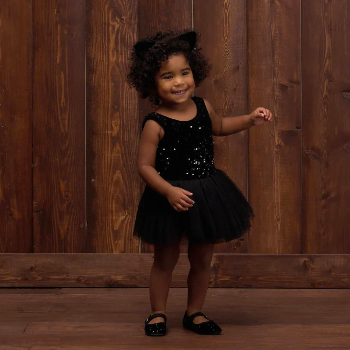 a black sequin tutu dress onesie. 