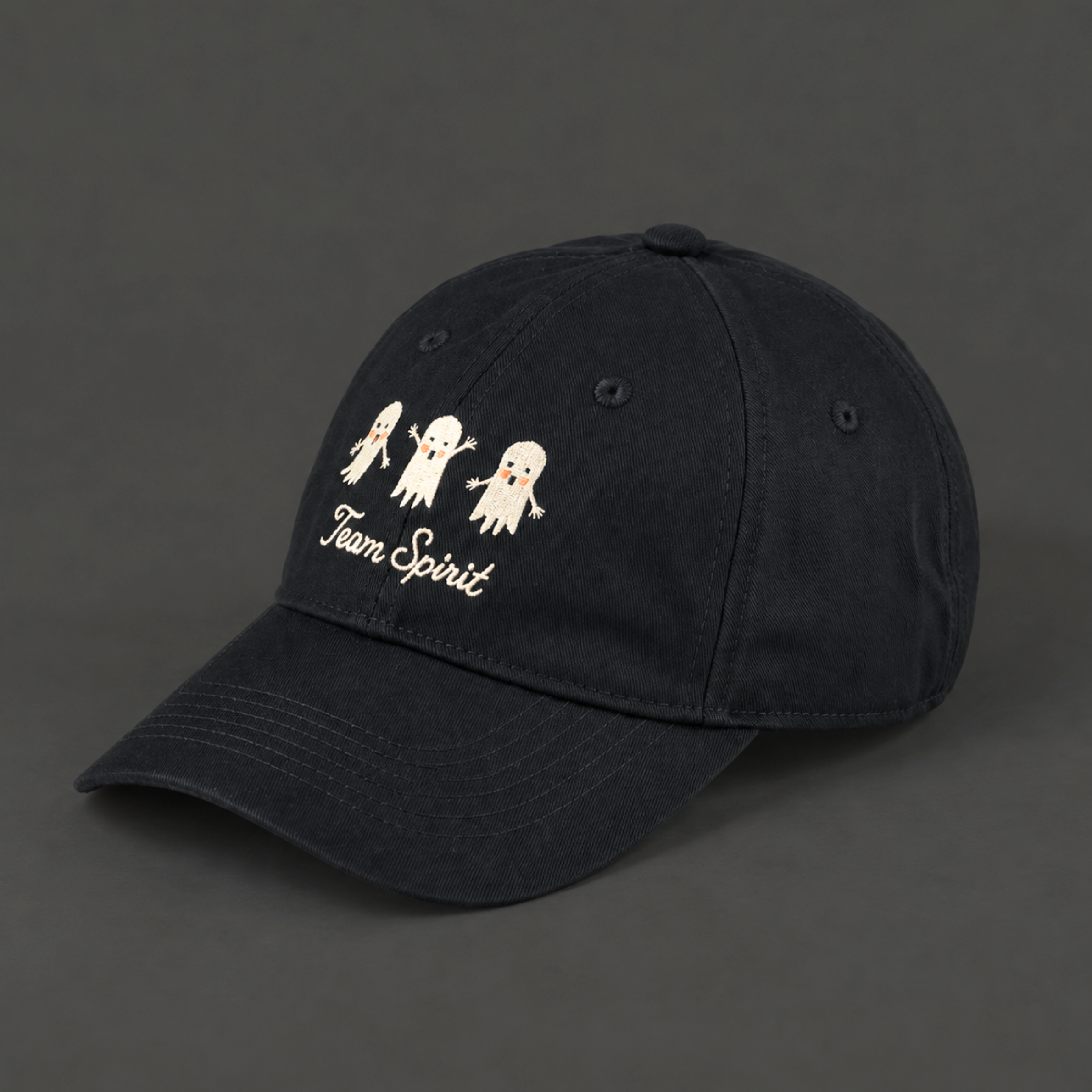 a black baseball hat with white embroidered text that reads, "Team Spirit" with three embroidered ghosts. 