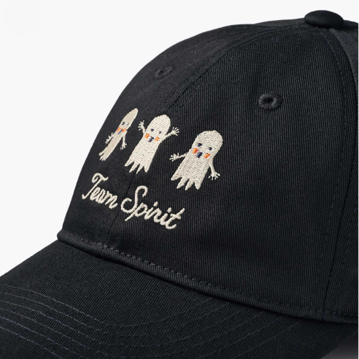 a black baseball hat with white embroidered text that reads, "Team Spirit" with three embroidered ghosts. 
