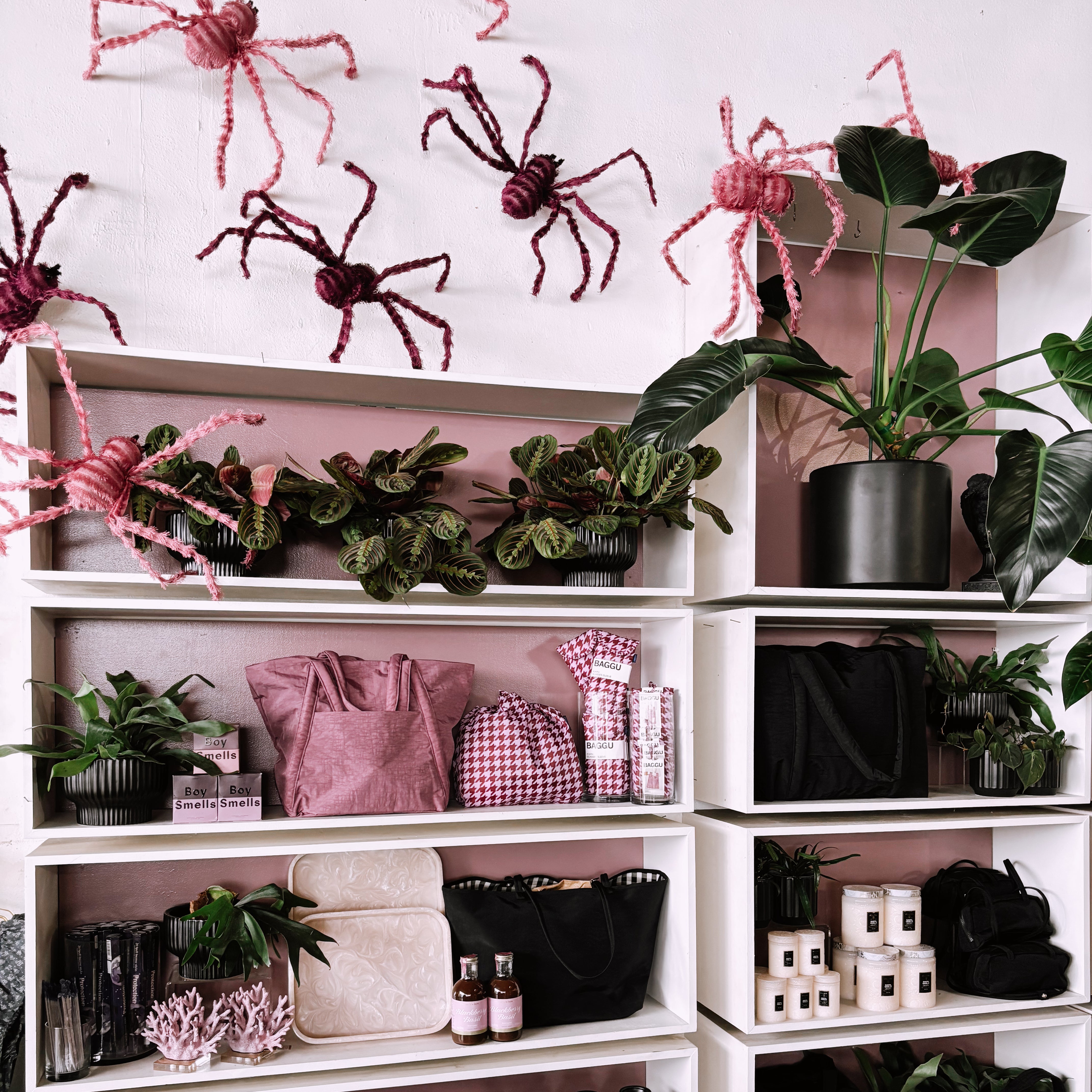 A display with pink spiders crawling up the wall. 