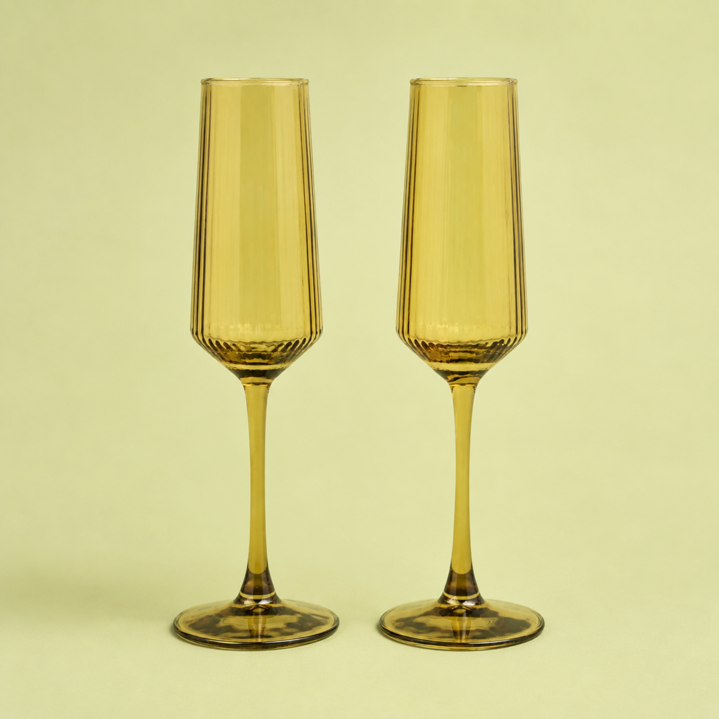 A set of olive colored glass champagne flutes