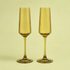 A set of olive colored glass champagne flutes