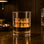 A clear glass tumbler with gold foiled text that reads, "Town Drunk". 