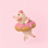 A felt pig shaped ornament sitting in a donut pool tube. 