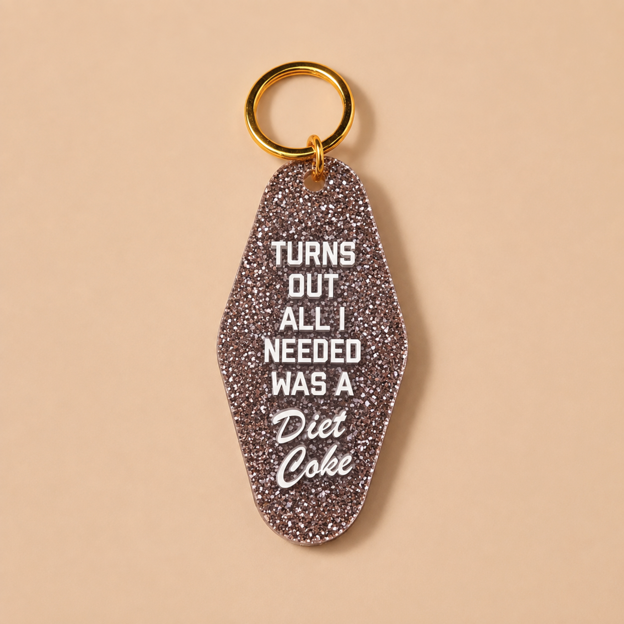 a keychain that reads, "turns out all i needed was a diet coke".