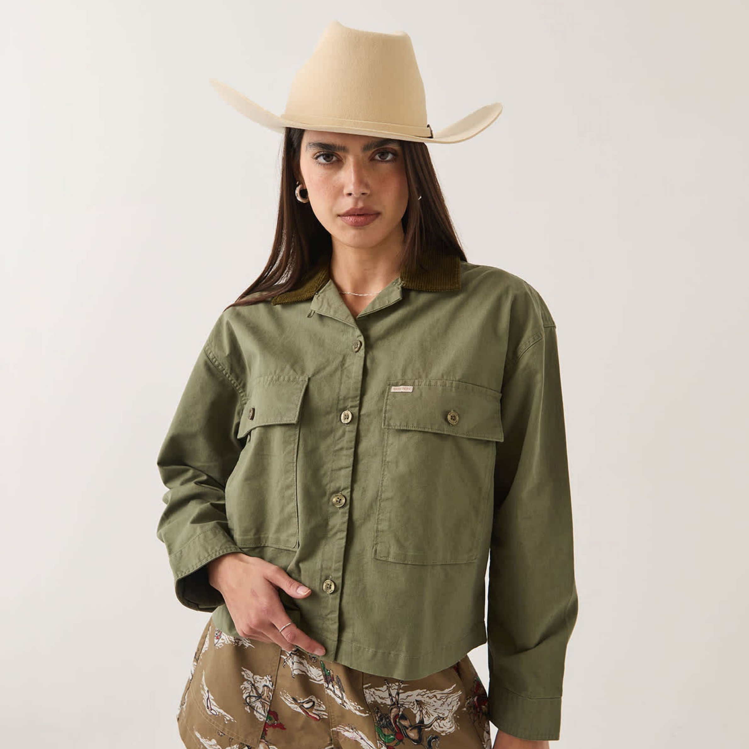 an army green jacket with a corduroy collar. 