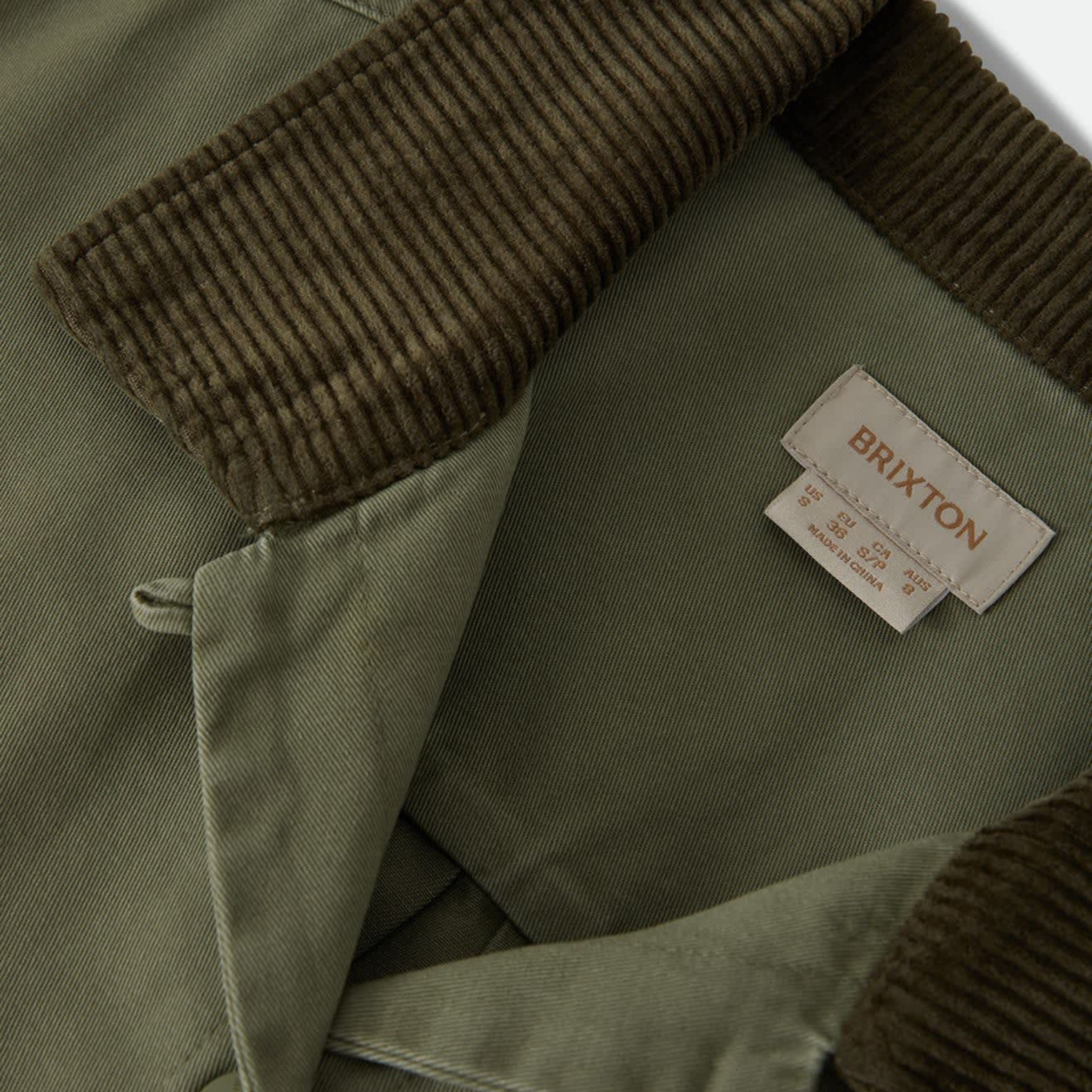 an army green jacket with a corduroy collar. 