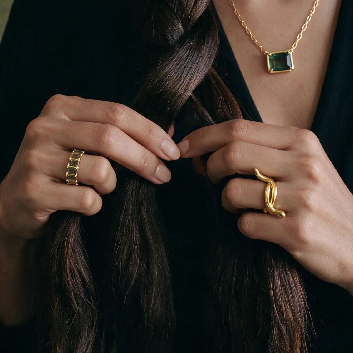 a gold ring with greens tones across the top.