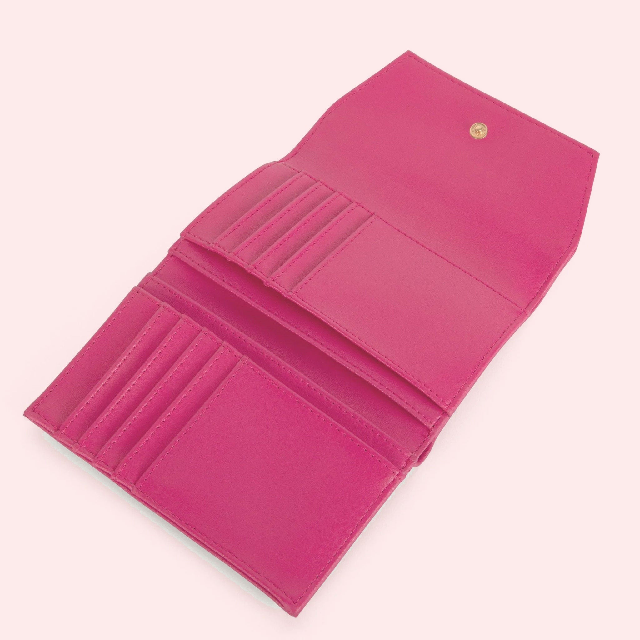 The interior of the pink wallet with 10 card slots and a button closure.