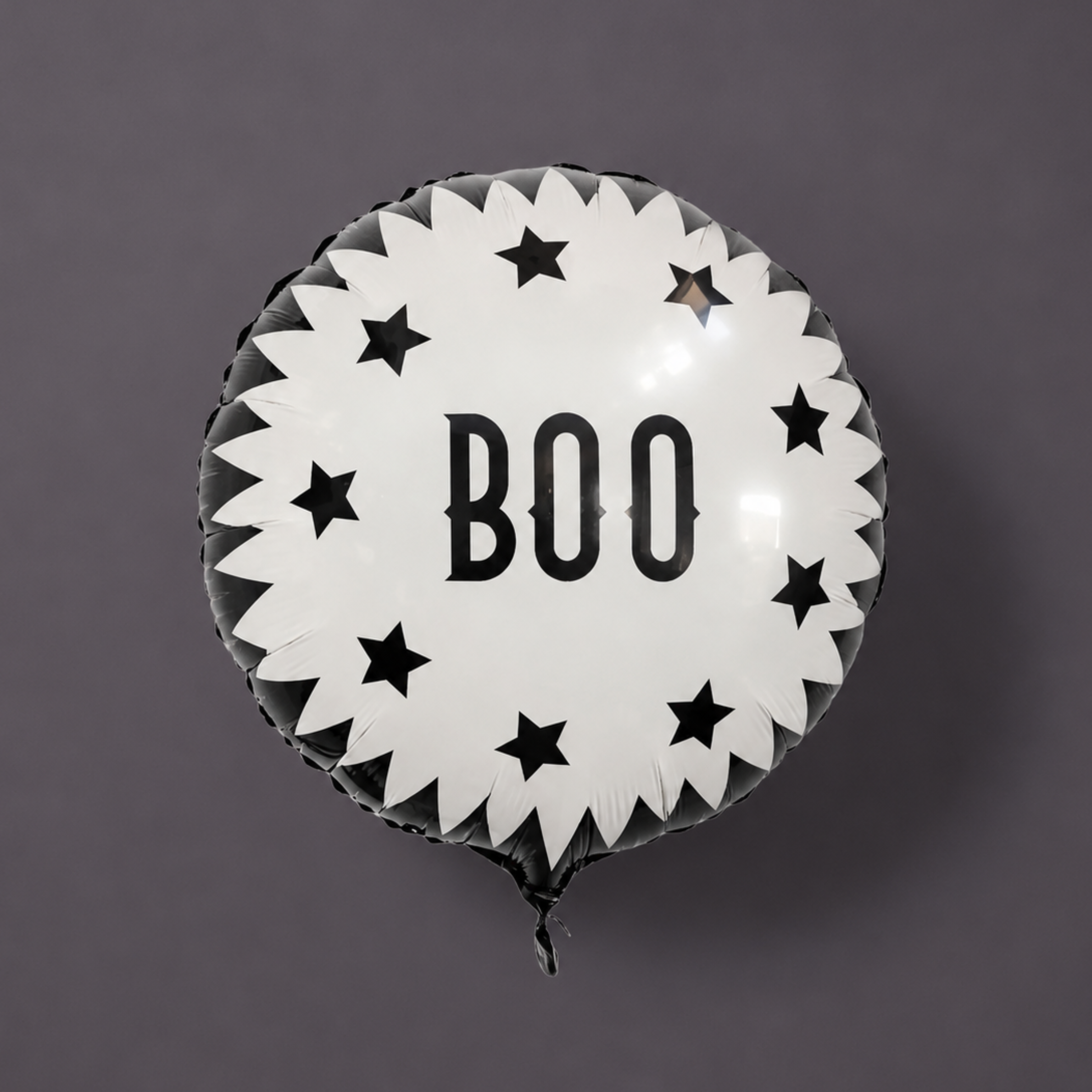 A black and white round balloon with "BOO" in the center.  