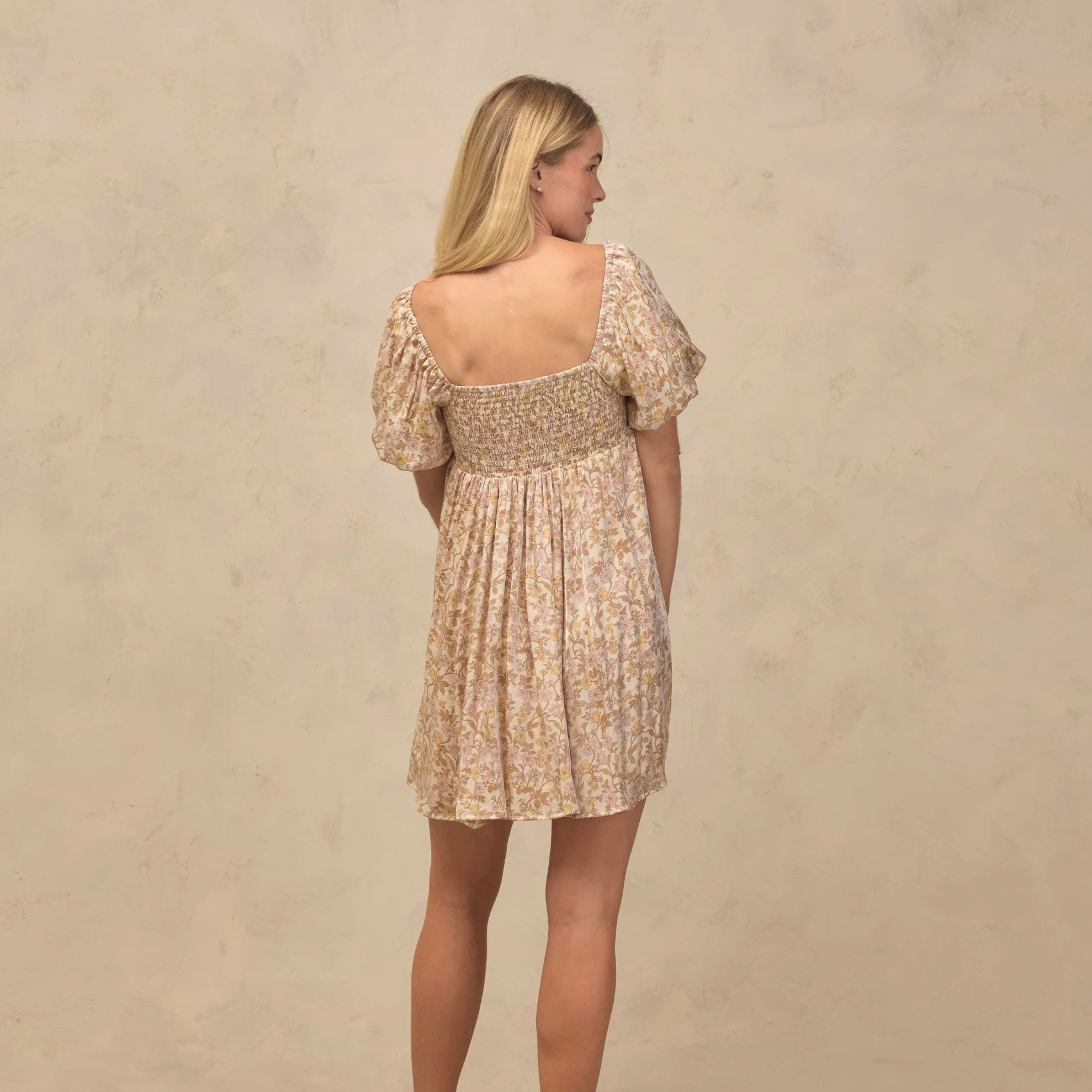 a neutral floral patterned mini dress with puff short sleeves. 