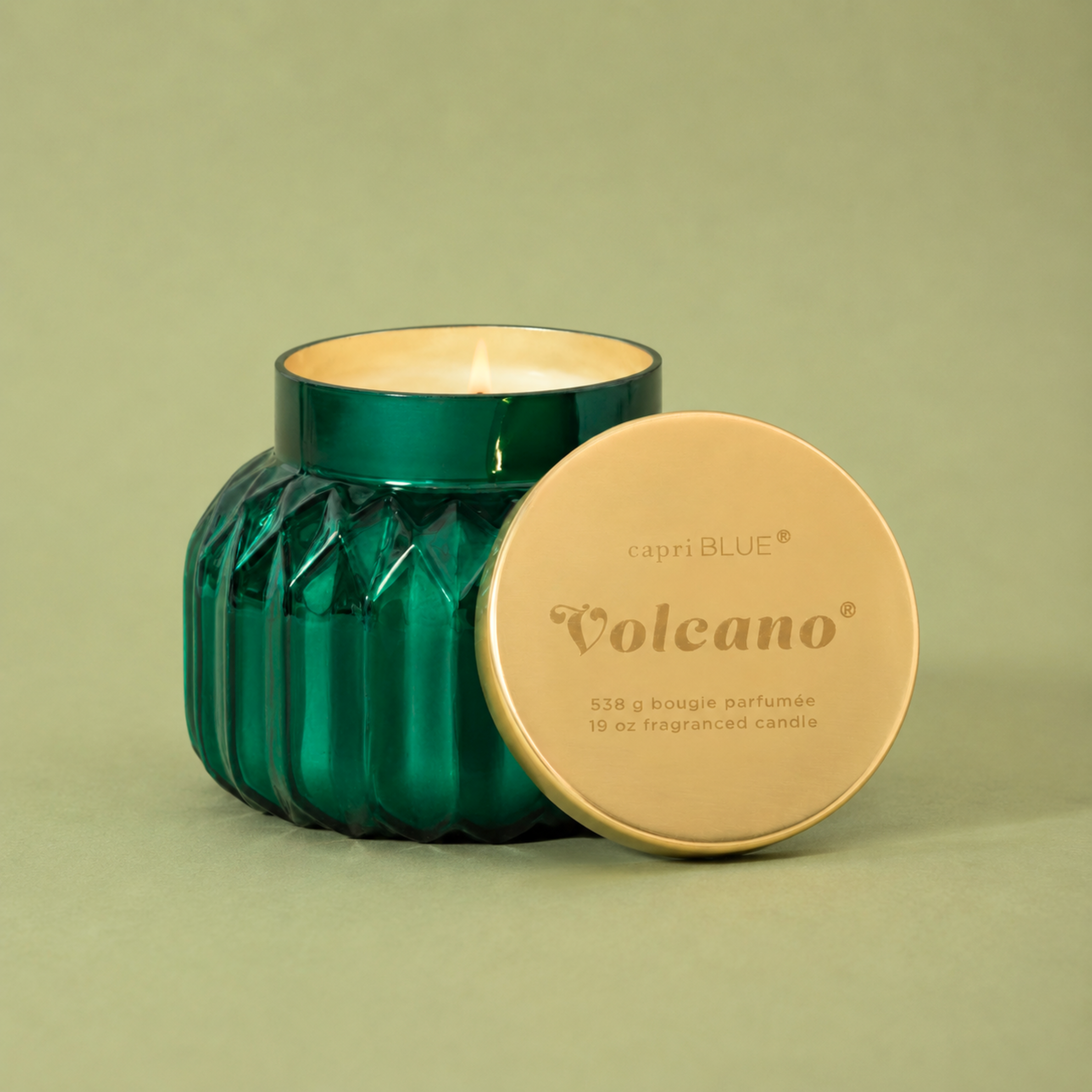 green glass jarred candles with a gold lid. 