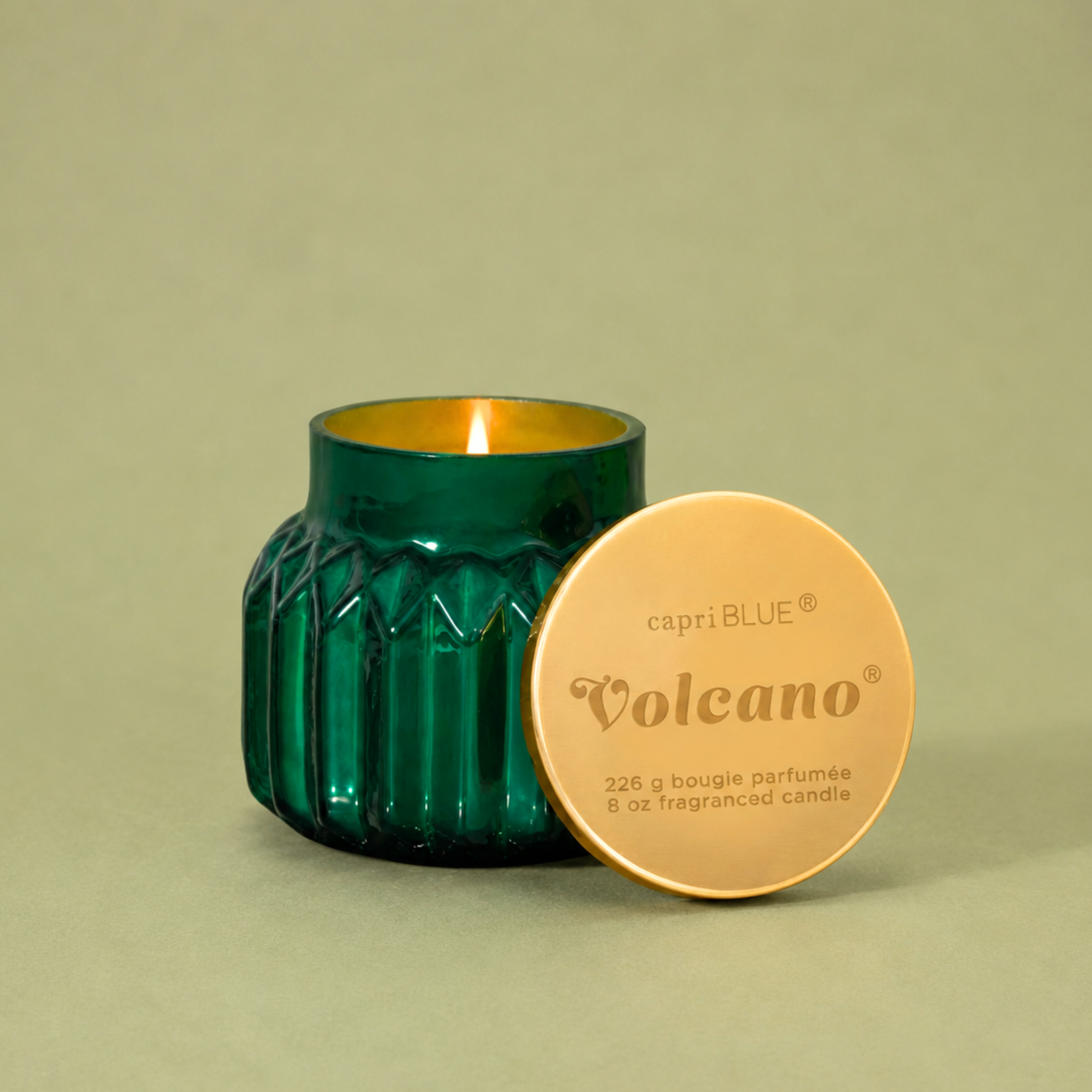 green glass jarred candles with a gold lid. 