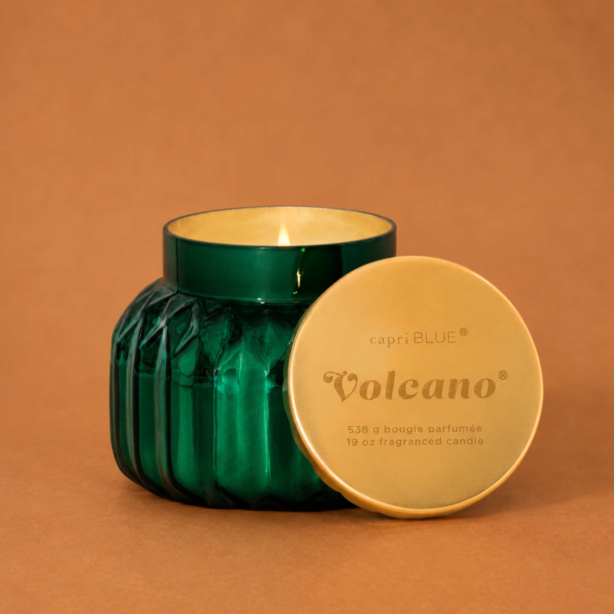 green glass jarred candles with a gold lid. 