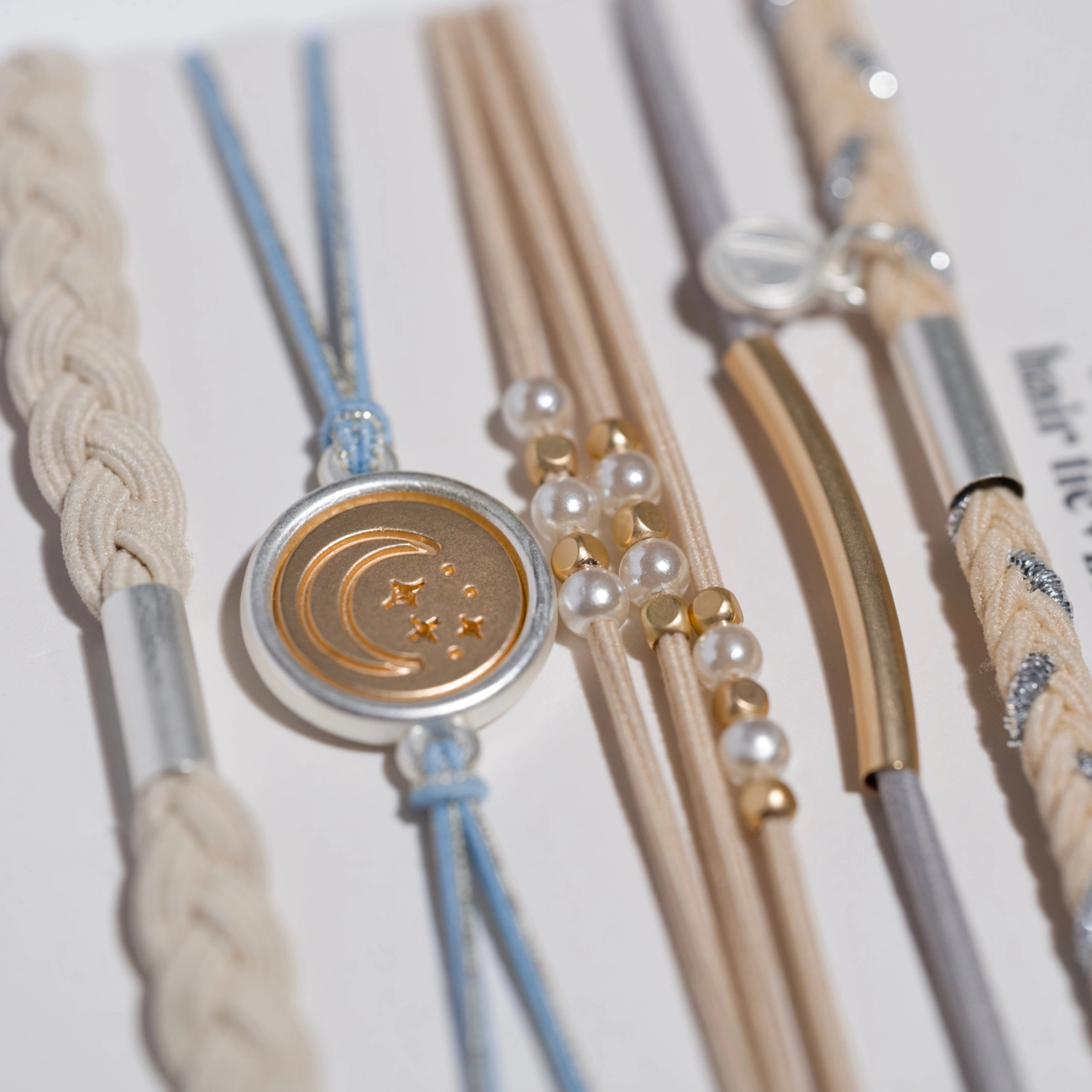 Collection of hair ties with decorative elements on a light background
