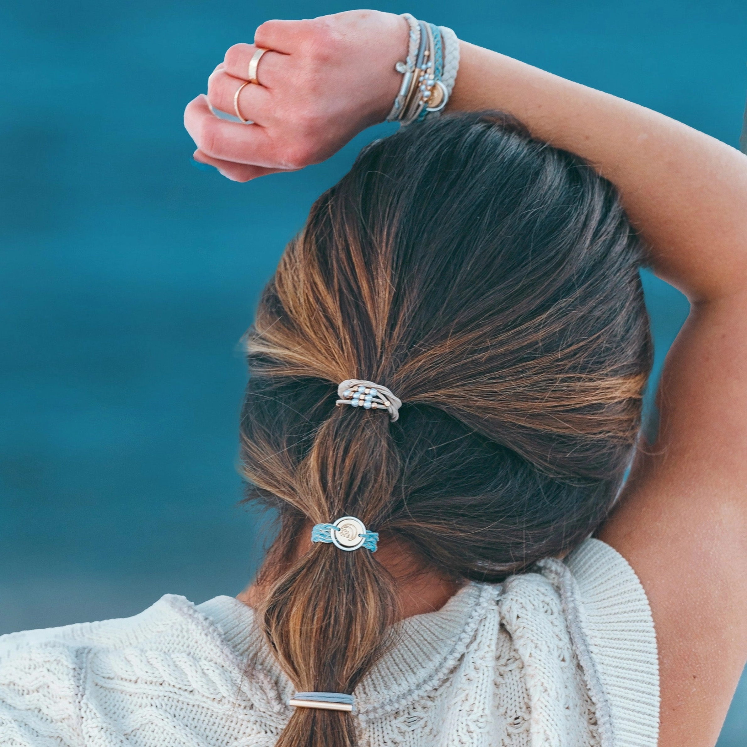 Collection of hair ties with decorative elements on a light background