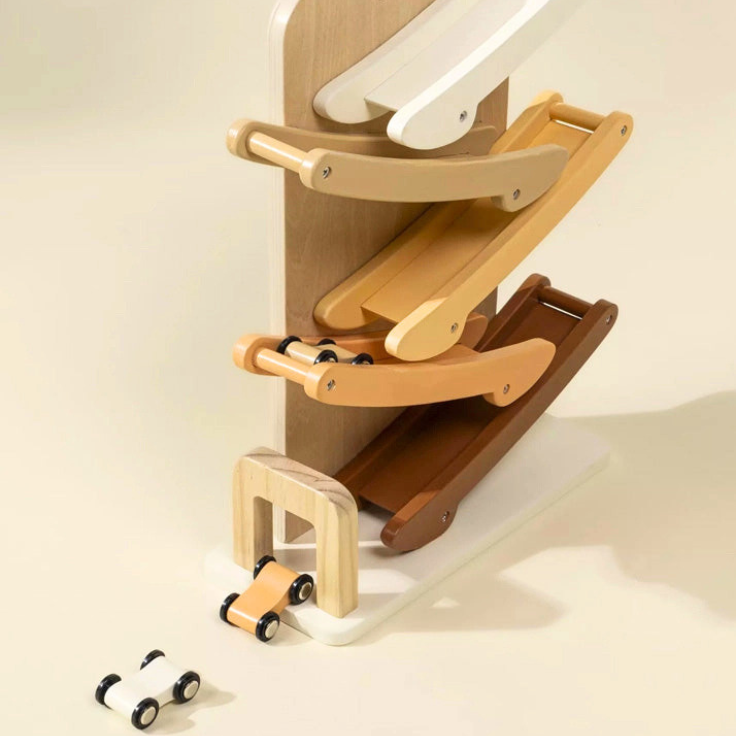 Wooden toy with multiple levels and small cars on a beige background
