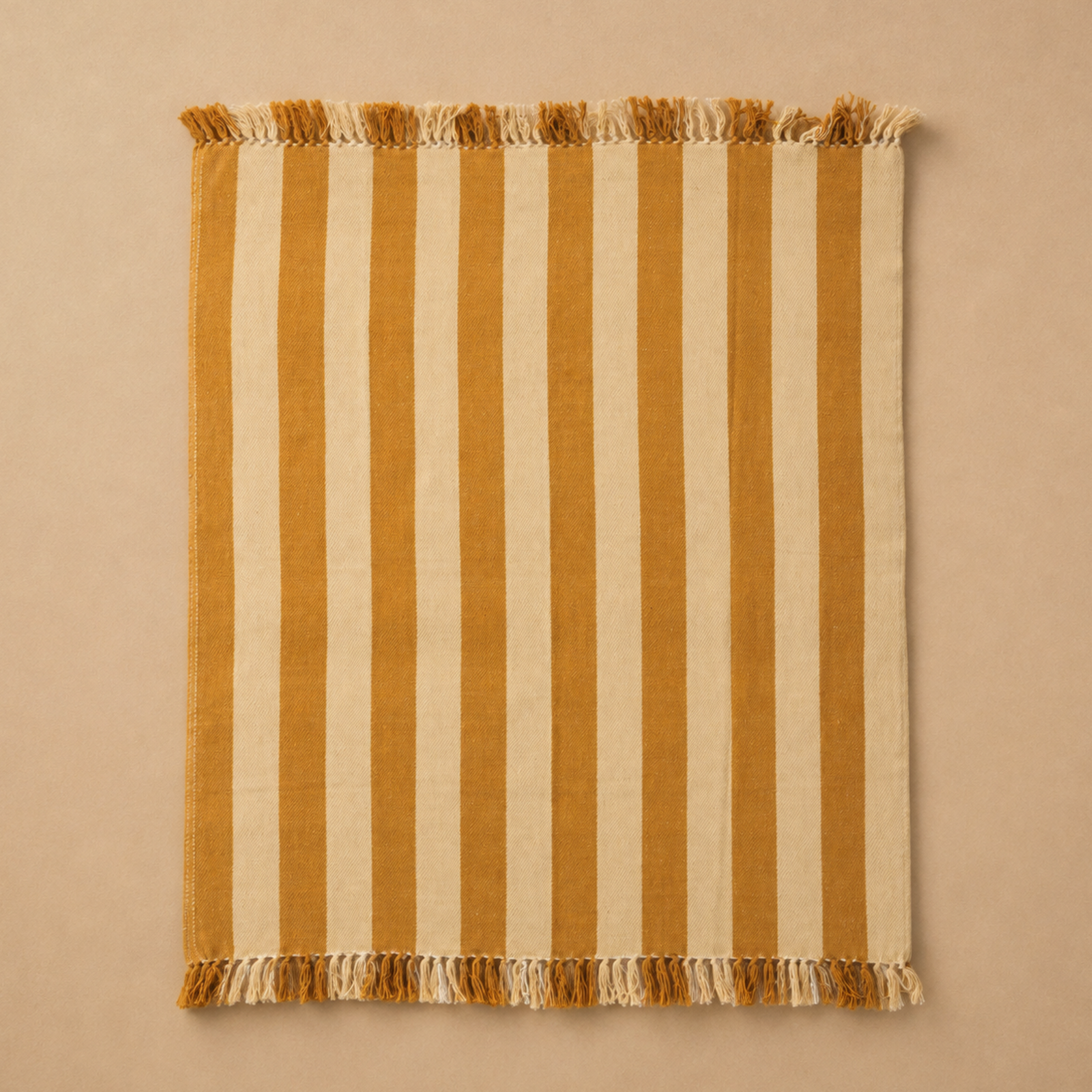 a yellow and tan woven striped throw blanket