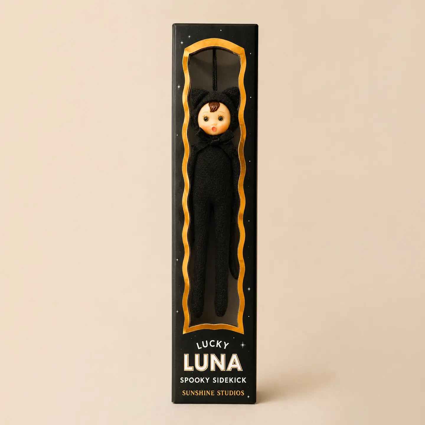 A packaged novelty sidekick doll labeled 'LUCKY LUNA SPOOKY SIDEKICK' by Sunshine Studios, shown in a tall black box with a gold-trimmed window and a black cat costumed doll inside. 