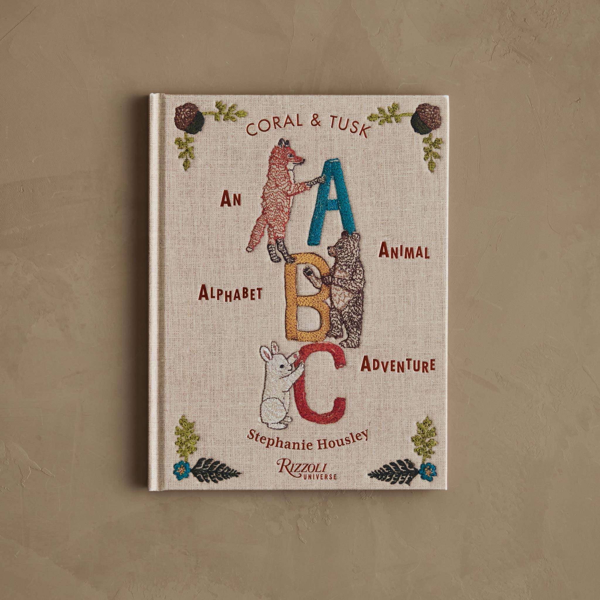 The cover of ABC: An Animal Alphabet Adventure shows illustrated animals climbing and holding the letters A, B, and C on a linen-textured background.