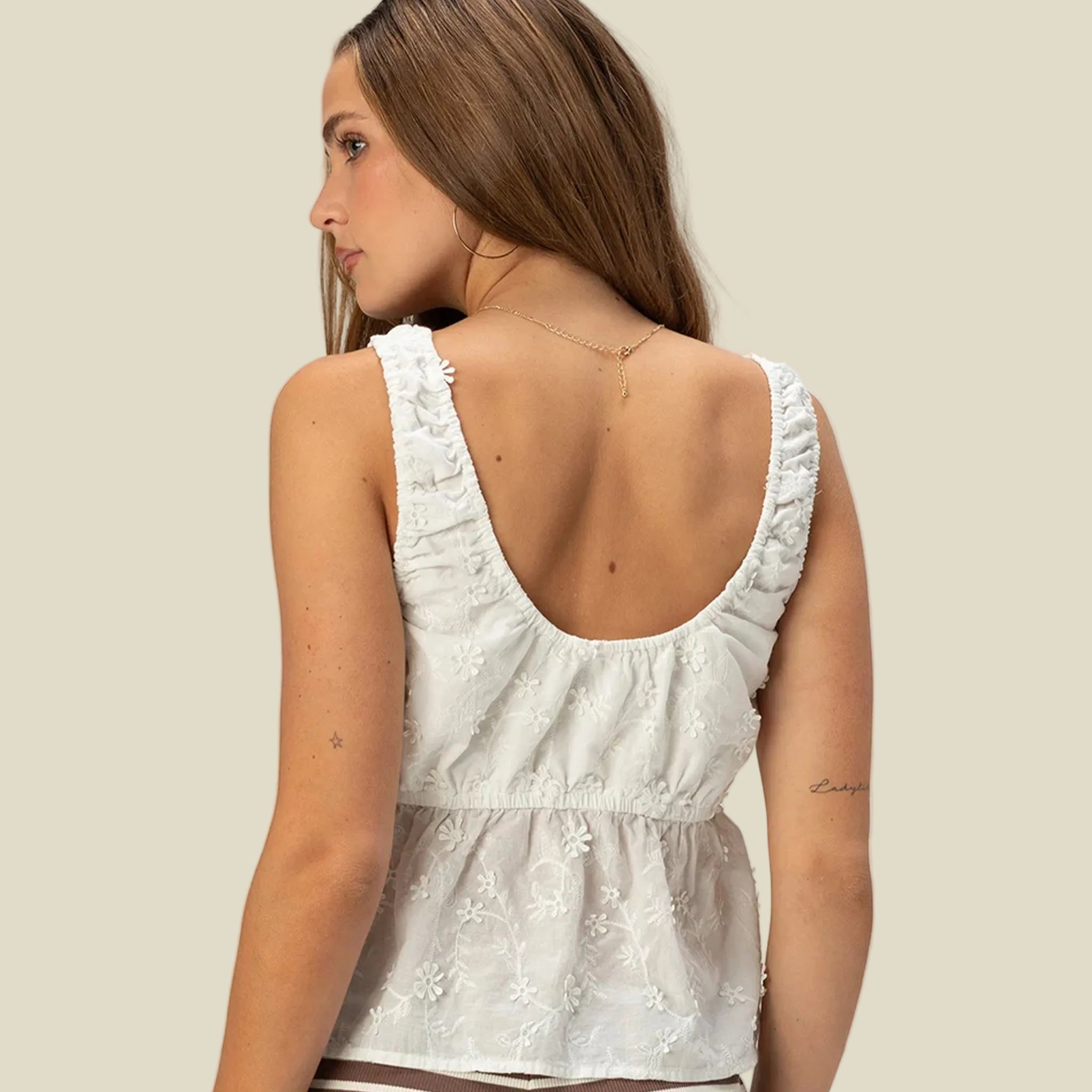 A white flower printed tank top. 