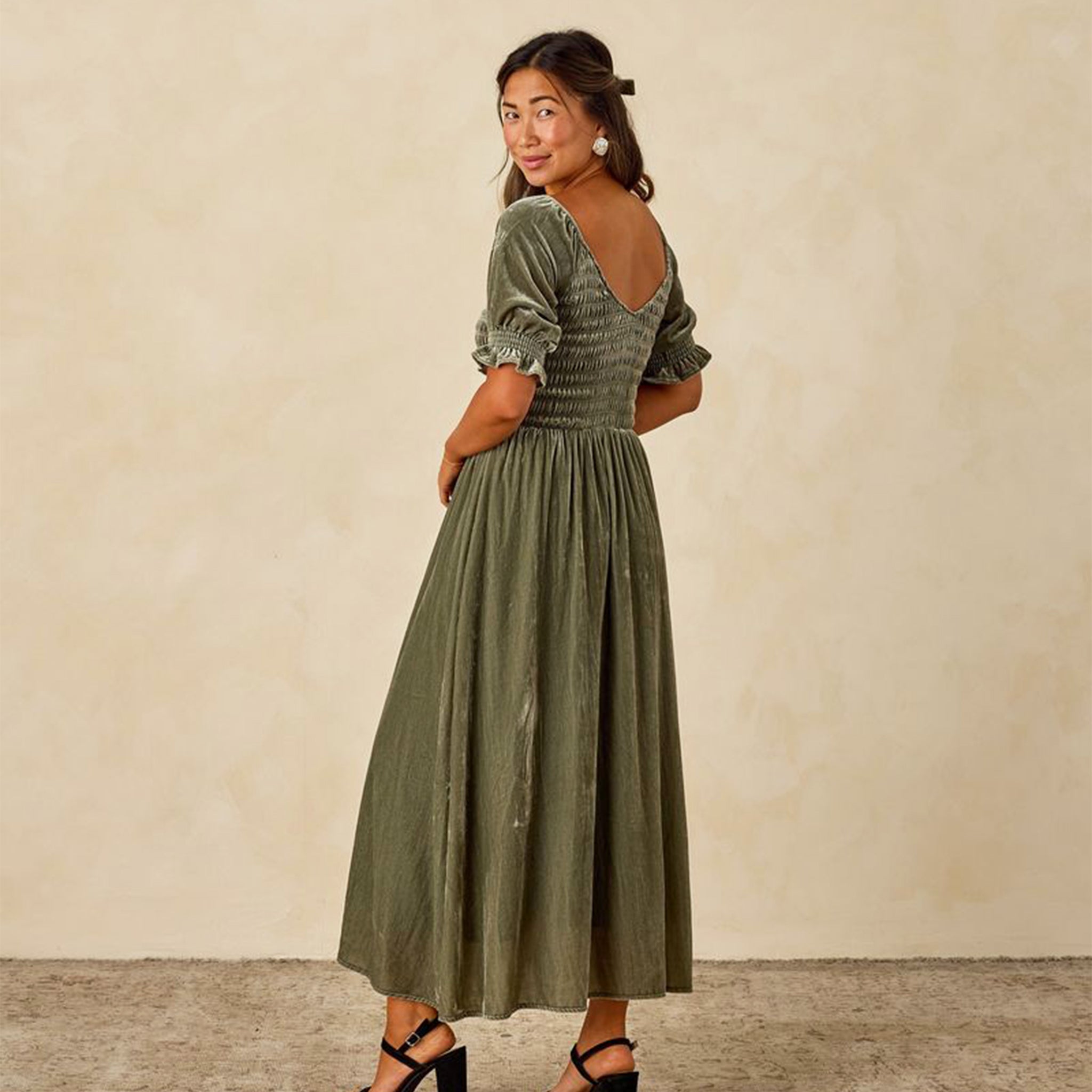 A velvet green dress with short sleeves and a v back. 