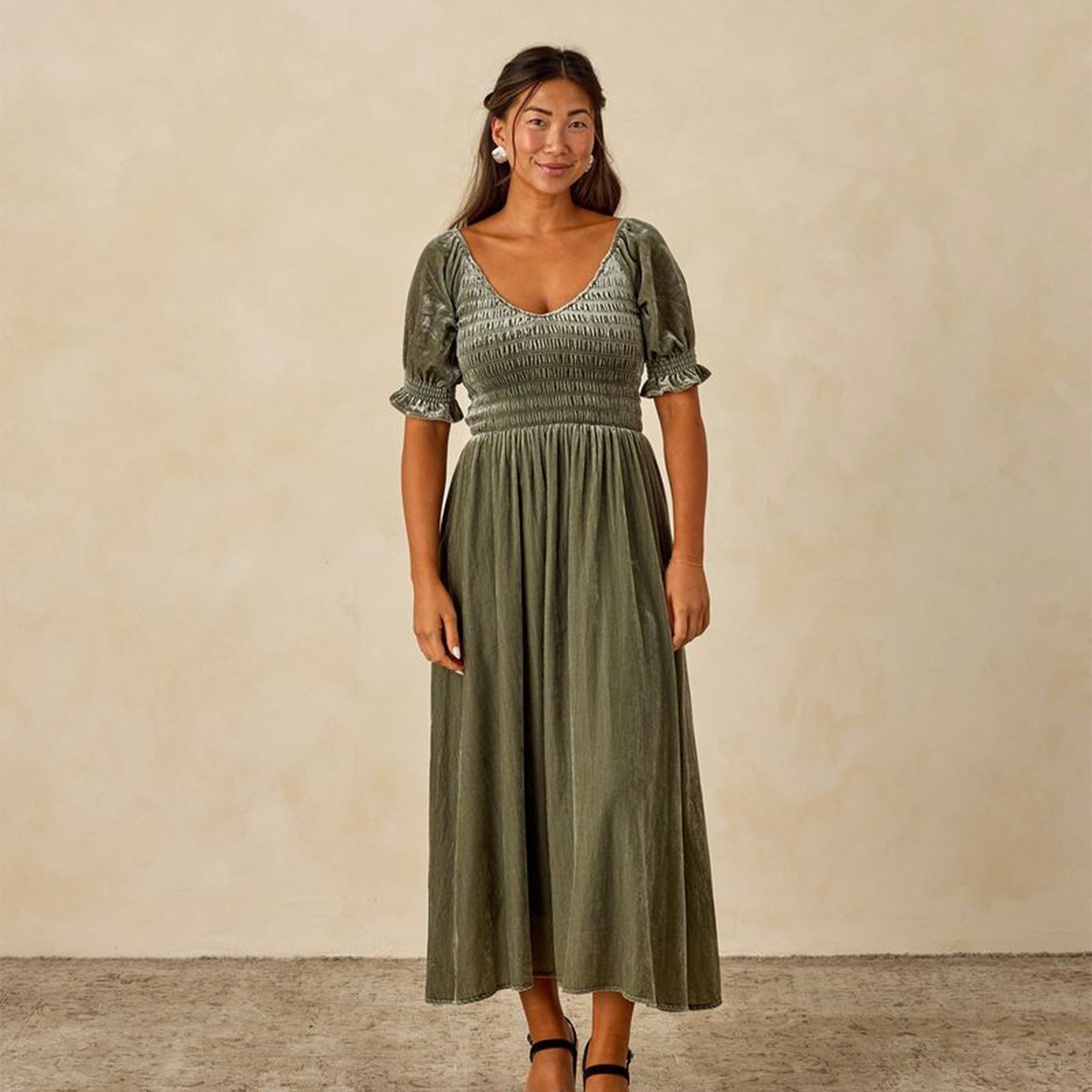A velvet green dress with short sleeves and a swoop neck.  