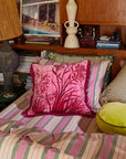 A hot pink floral pillow cushion. 