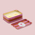 A tin pink and orange striped rectangle candle. 