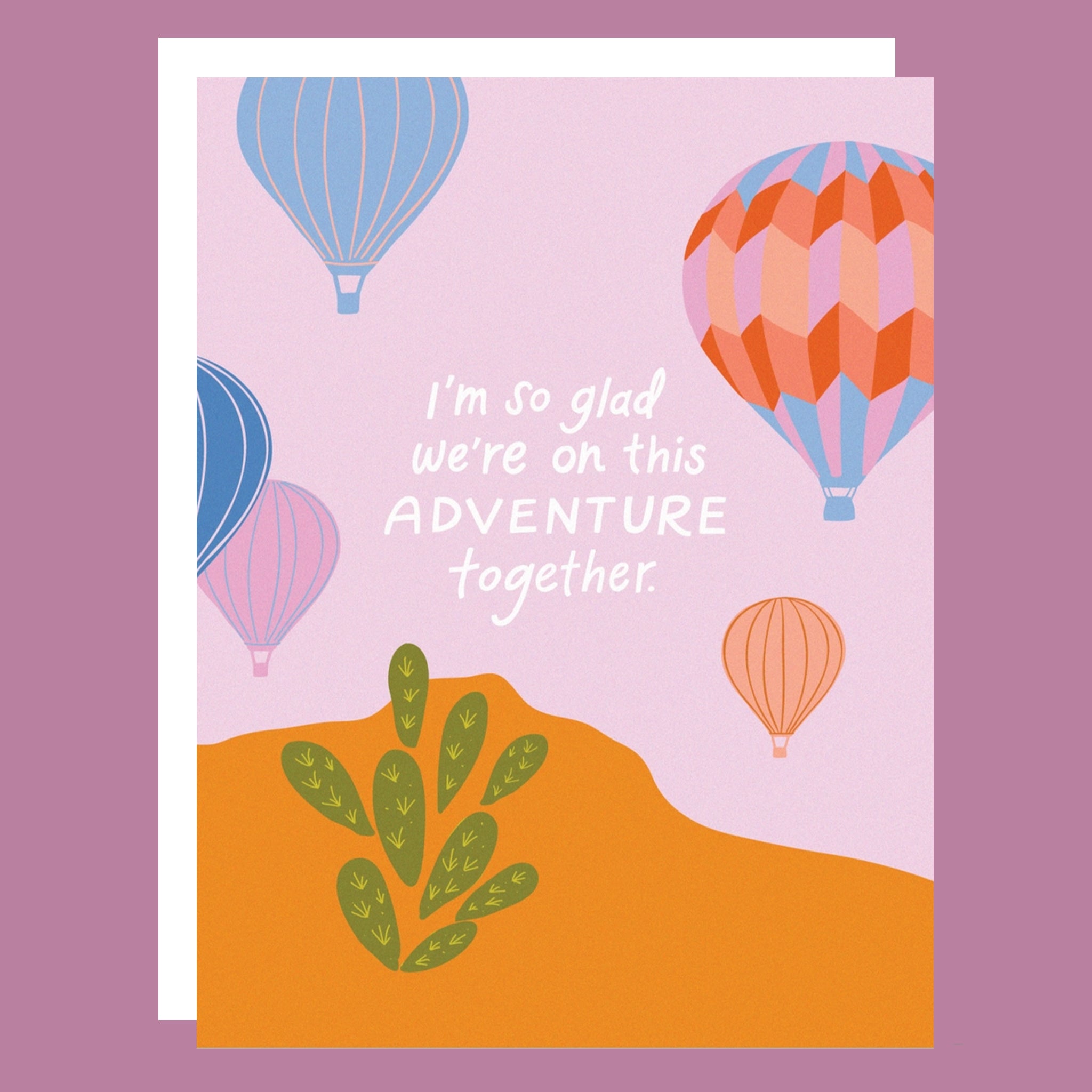 a purple and orange card with air balloon graphics and white text in the center that reads, &quot;I&#39;m so glad we&#39;re on this Adventure together&quot;. 