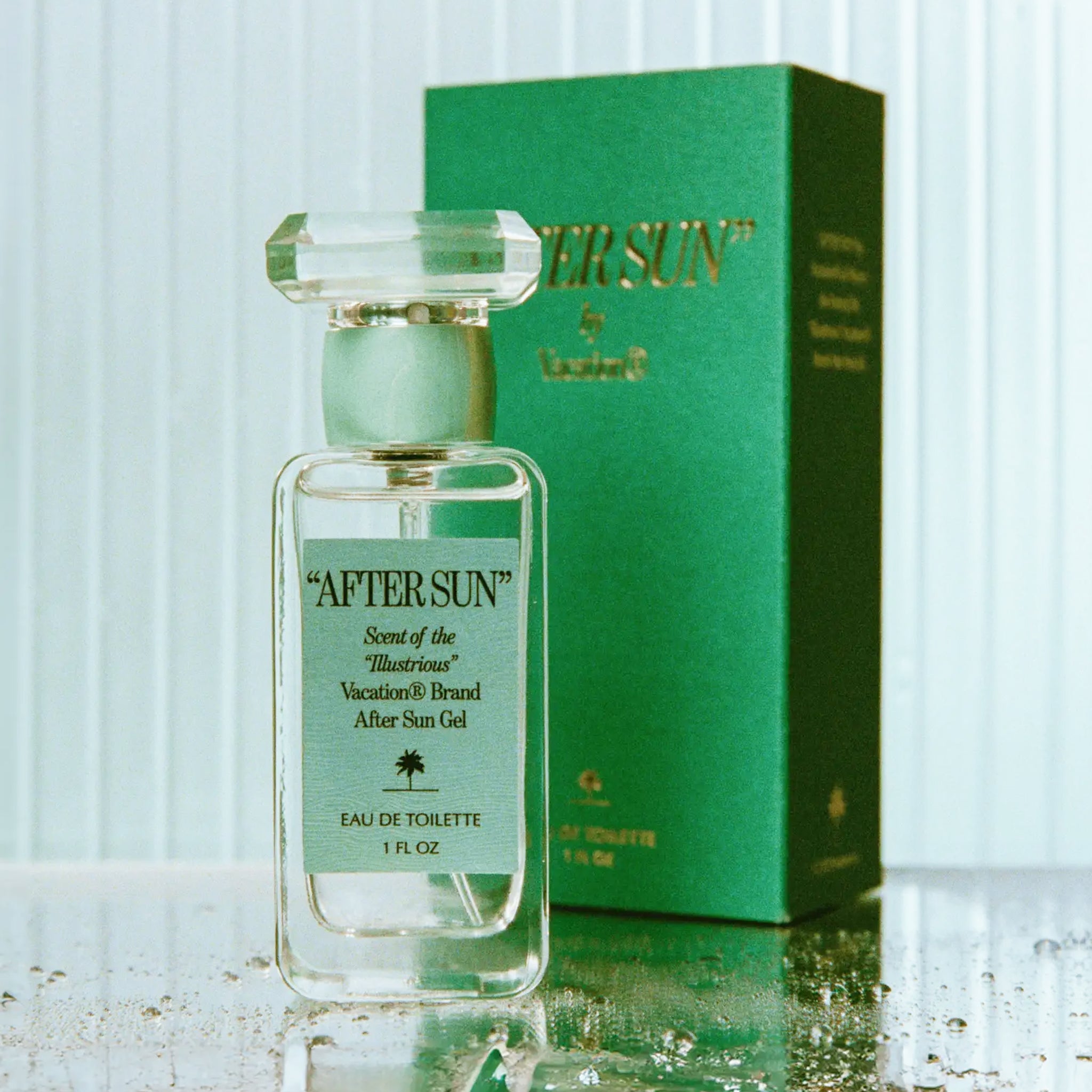 A box of perfume and a clear bottle with a teal blue label on the front that reads, "After Sun Scent of the Illustrious".