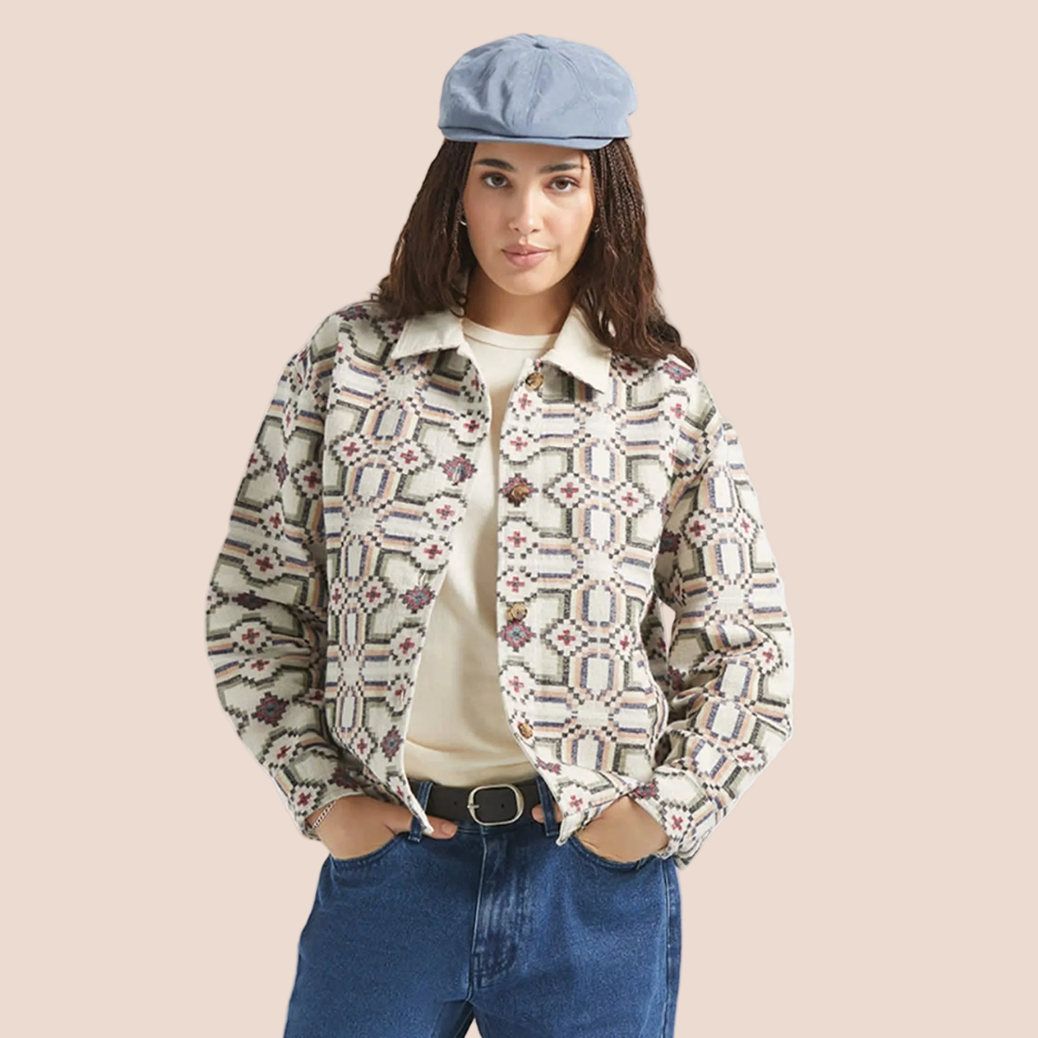 A button up jacket with a collar and a geometric print. 