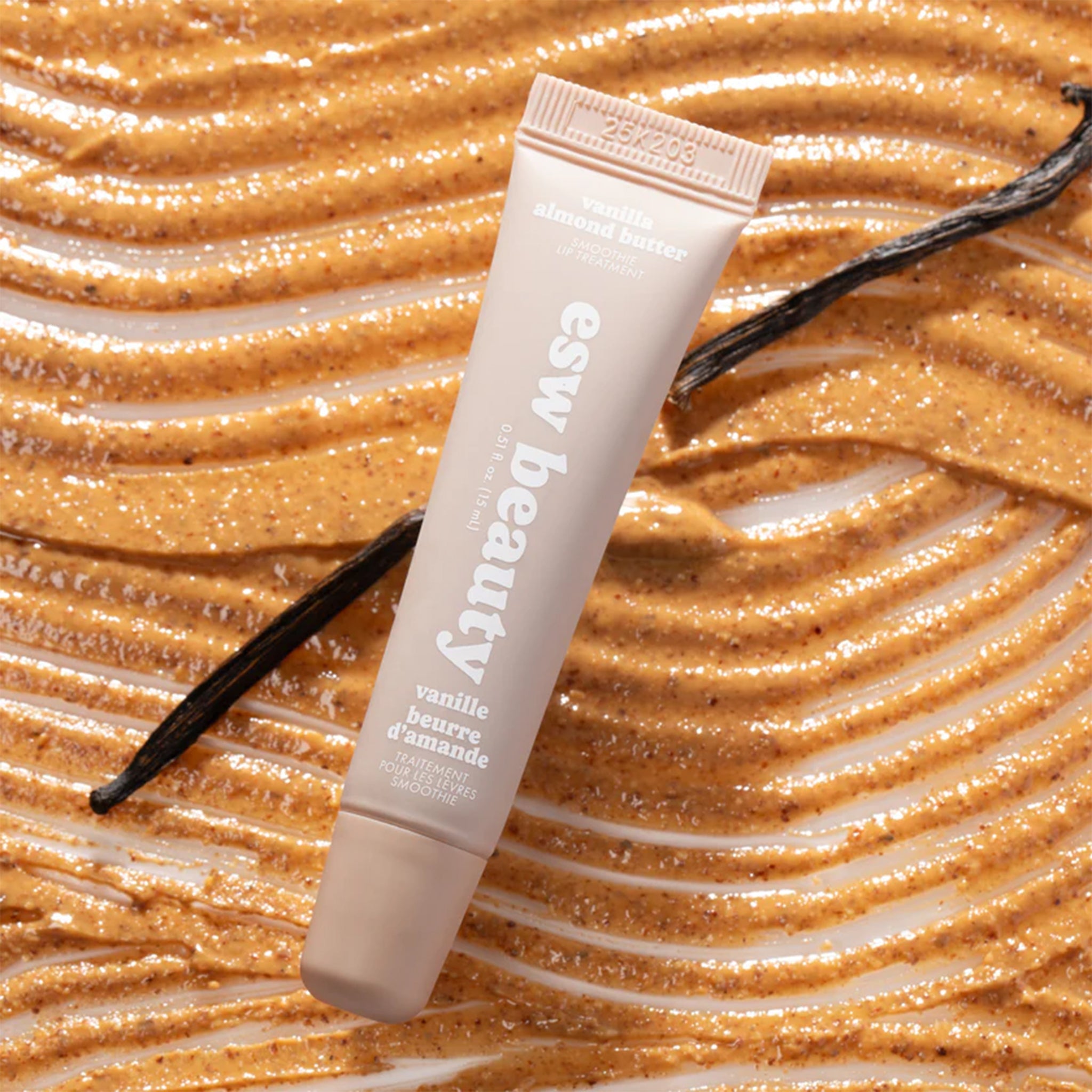A neutral tan colored tube of lip butter with text that reads, 'Vanilla Almond Butter Smoothie'. 