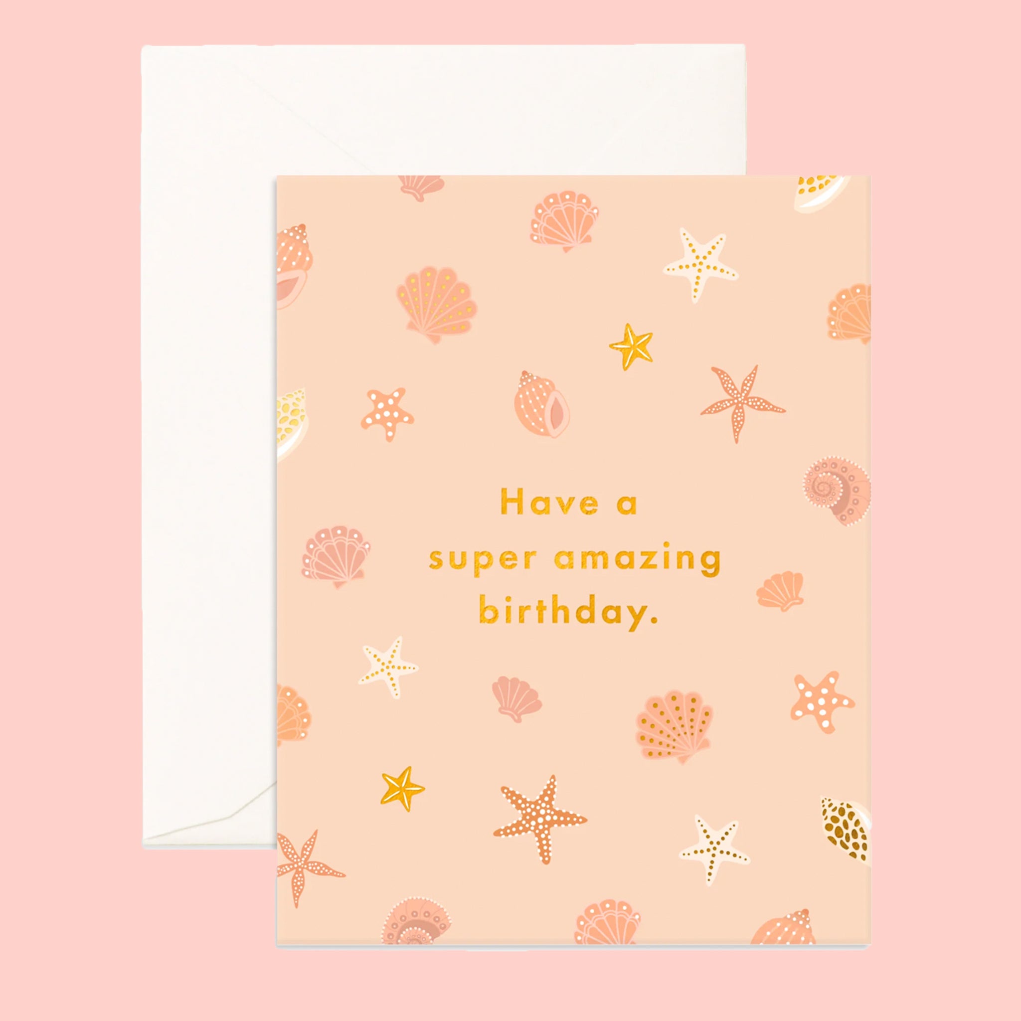 On a pink background is a apricot colored card with a shell pattern and gold foiled text that reads, &quot;Have a super amazing birthday.&quot;. 