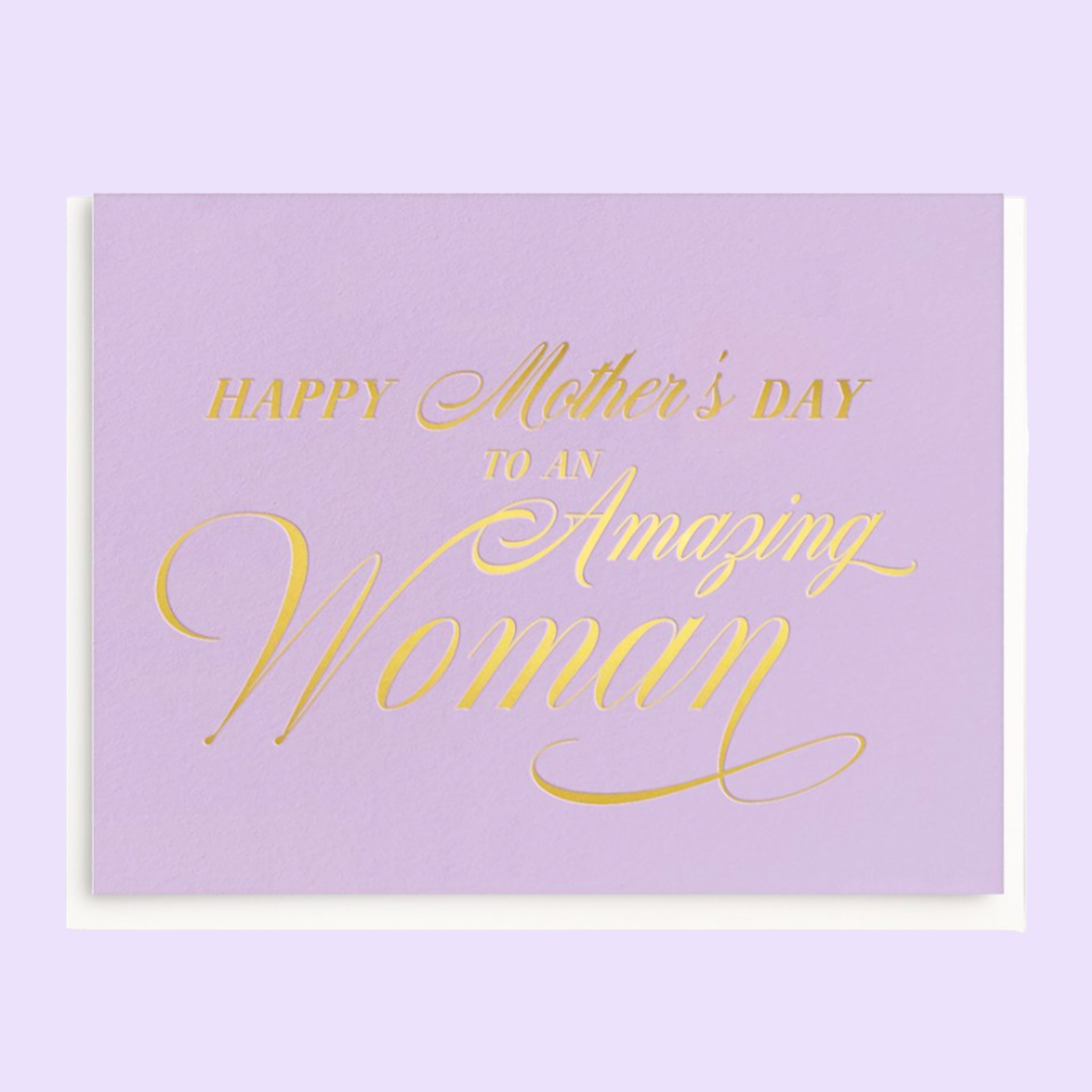 A light purple greeting card with white envelope with gold foil font &quot;Happy Mother&#39;s Day to an Amazing Woman.&quot;