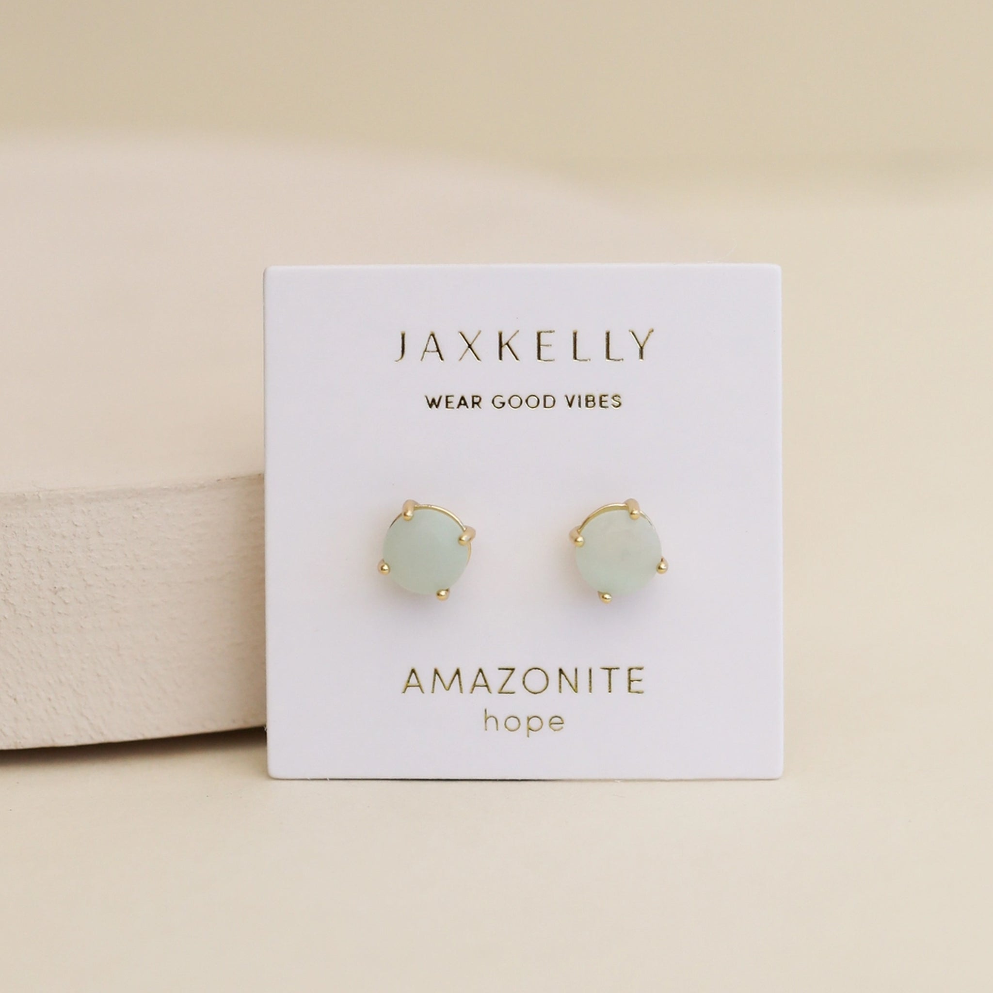 A light teal colored pair of round stud earrings.
