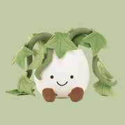 A stuffed animal toy in the shape of a potted ivy plant with a smiling face and brown corduroy lets and feet. 