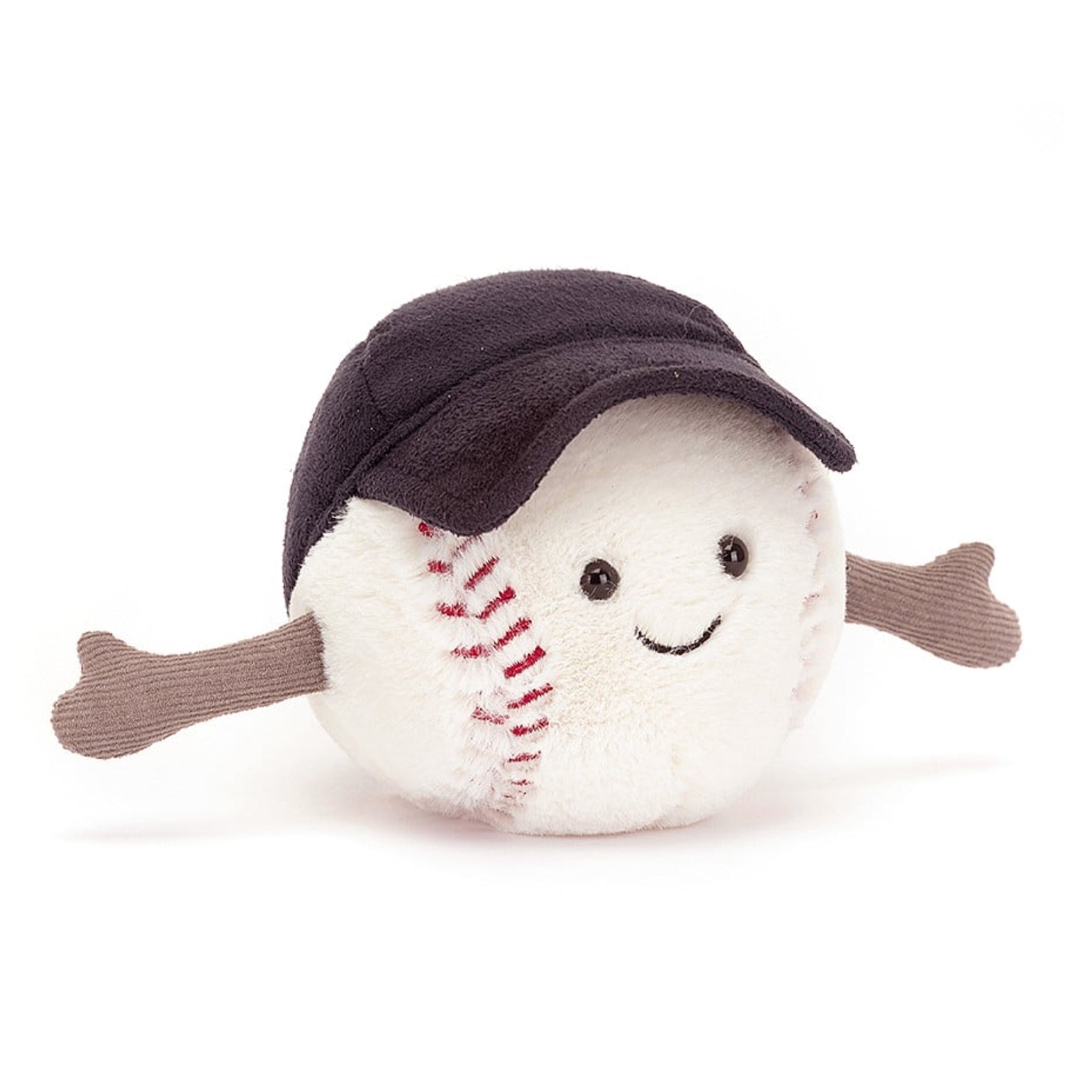 On a white background is a baseball shaped stuffed toy wearing a black baseball cap and a smiling face. 