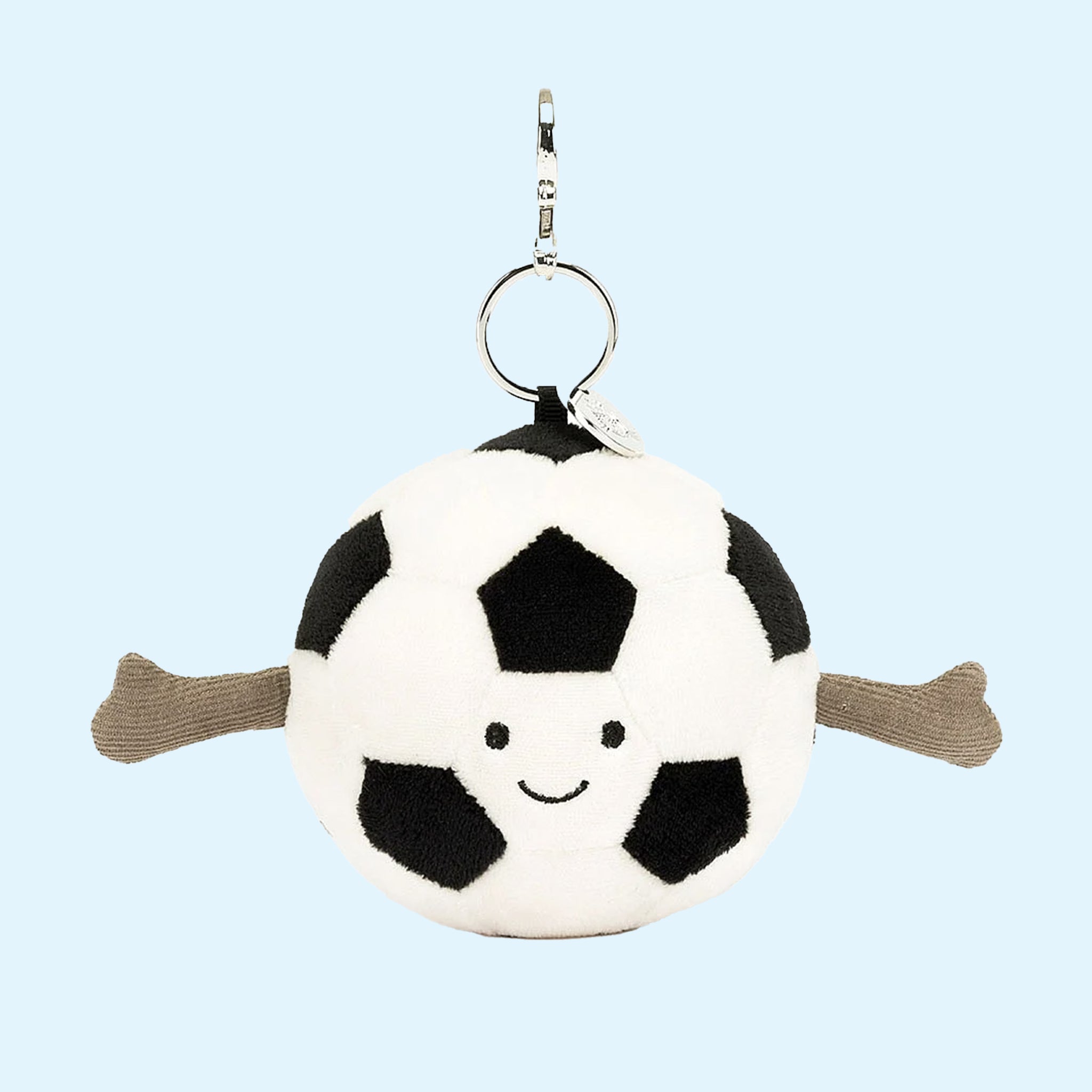 On a blue background is a black and white soccer ball shaped bag charm. 