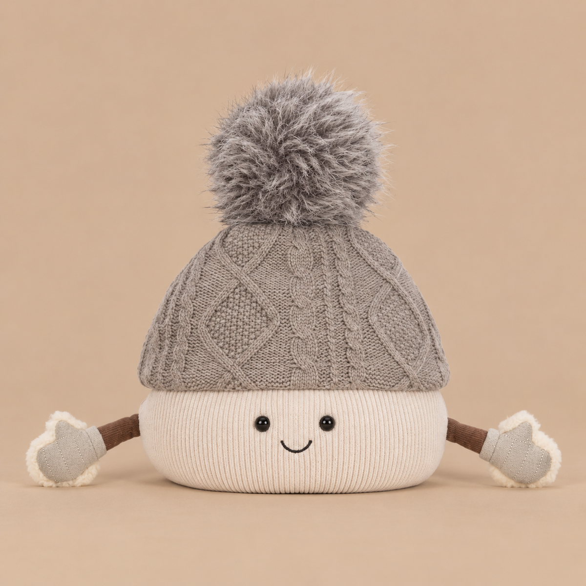 A beanie shaped plush character with arms and a smiling face. 