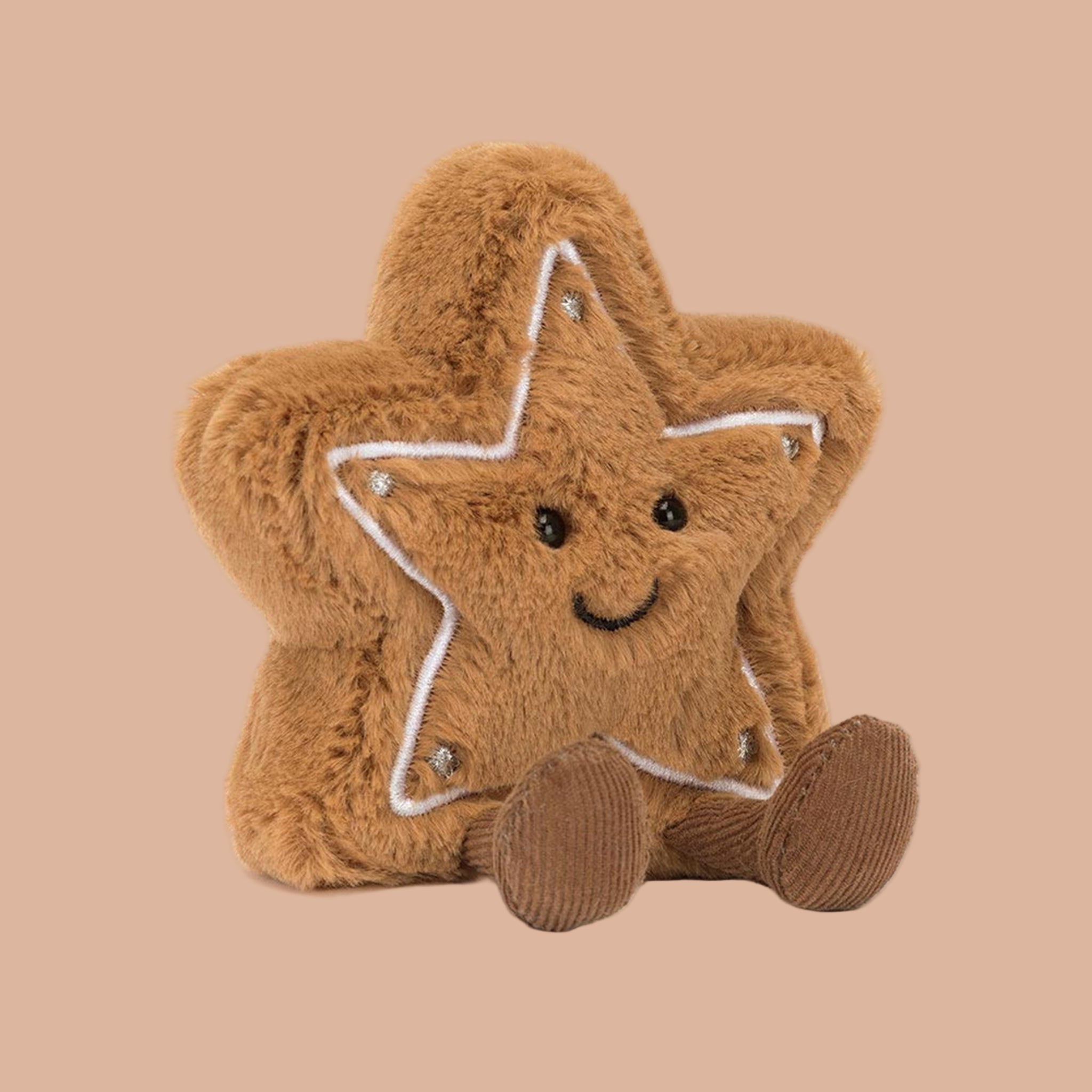 A brown star cookie shaped stuffed toy with a smiling face and brown legs and feet. 