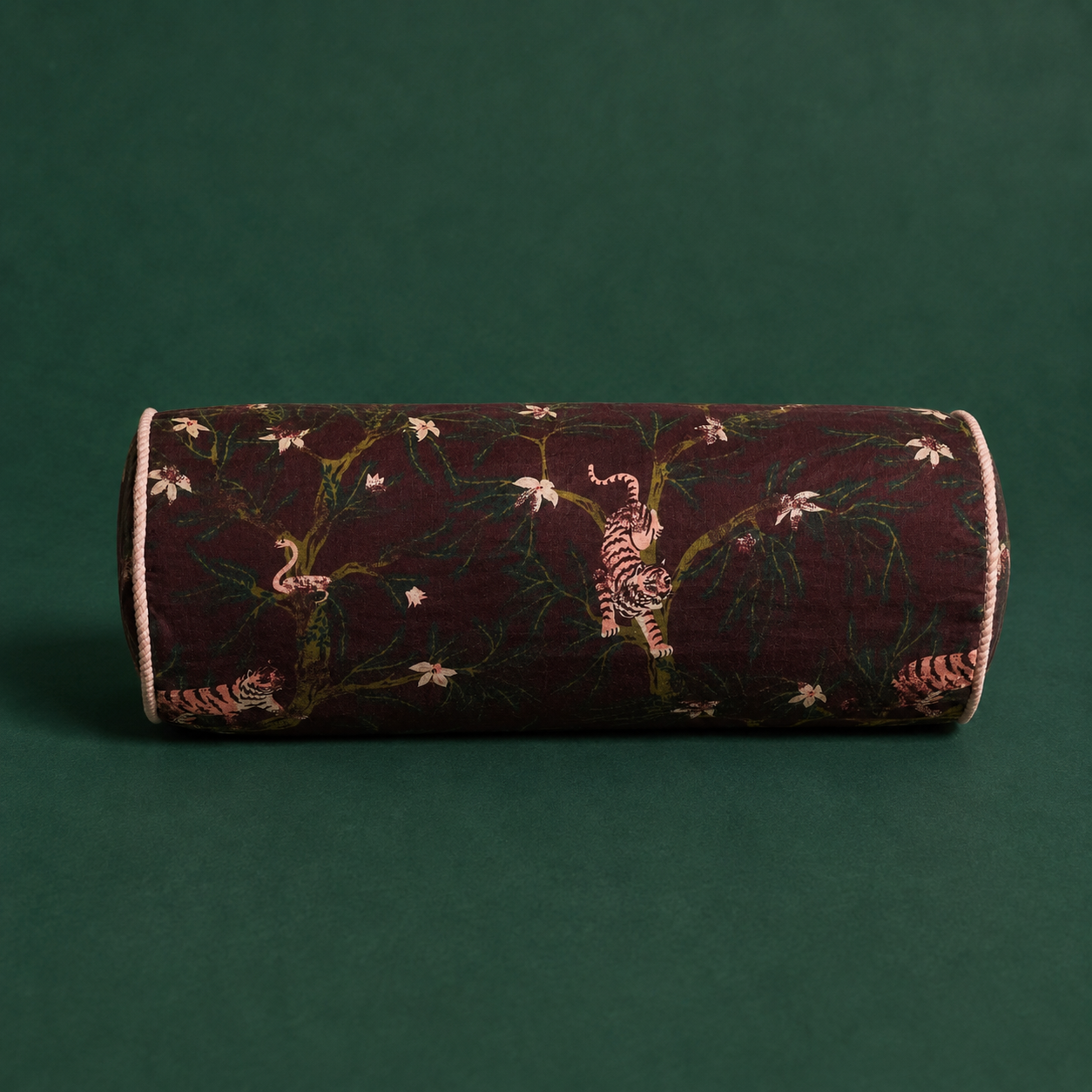 A bolster pillow with a tiger print. 