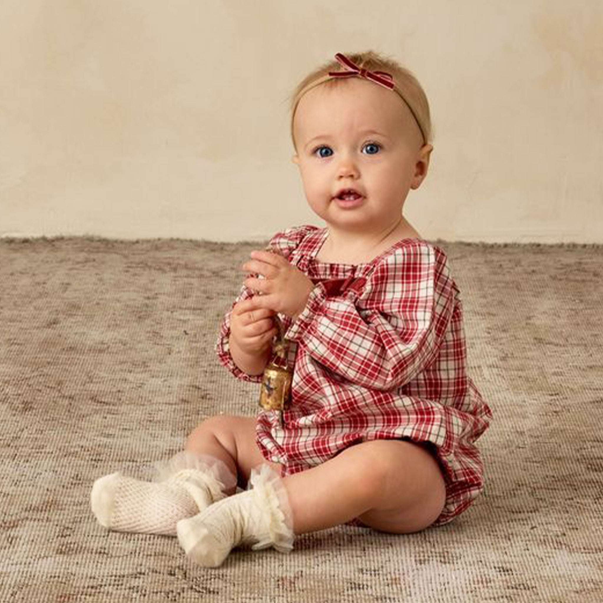 A ivory and red long sleeve romper. 