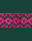 Bright pink, dark pink and dark teal bath mat with pink fringe. 