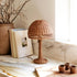 A mini brown rattan dome lamp. 