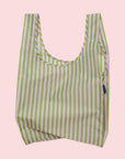 A light pink and green striped nylon reusable tote bag. 
